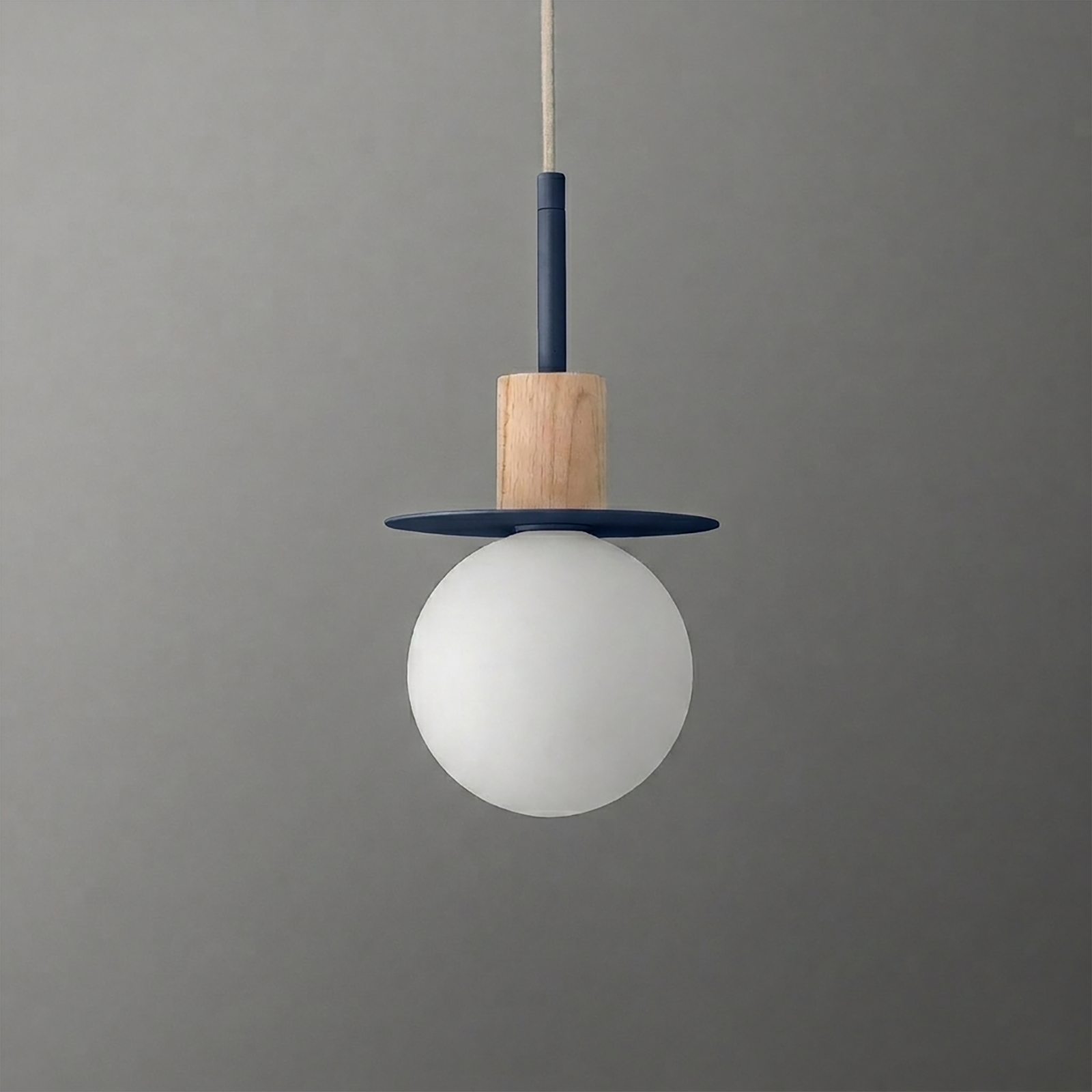 Pendant light with frosted white globe, wooden accent, and navy blue circular metal detail hanging from a beige cord. - PENDANT MODEL NO. 6198