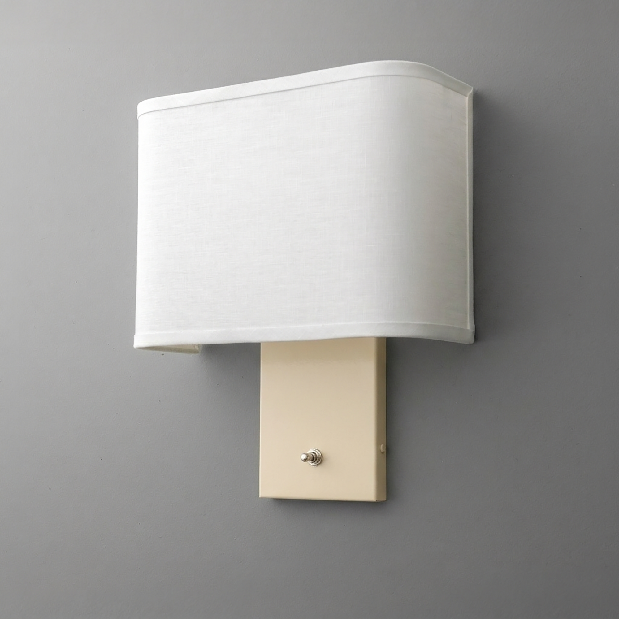 Beige rectangular wall sconce with a fabric lampshade and single toggle switch at the base. - SCONCE MODEL NO. 7769