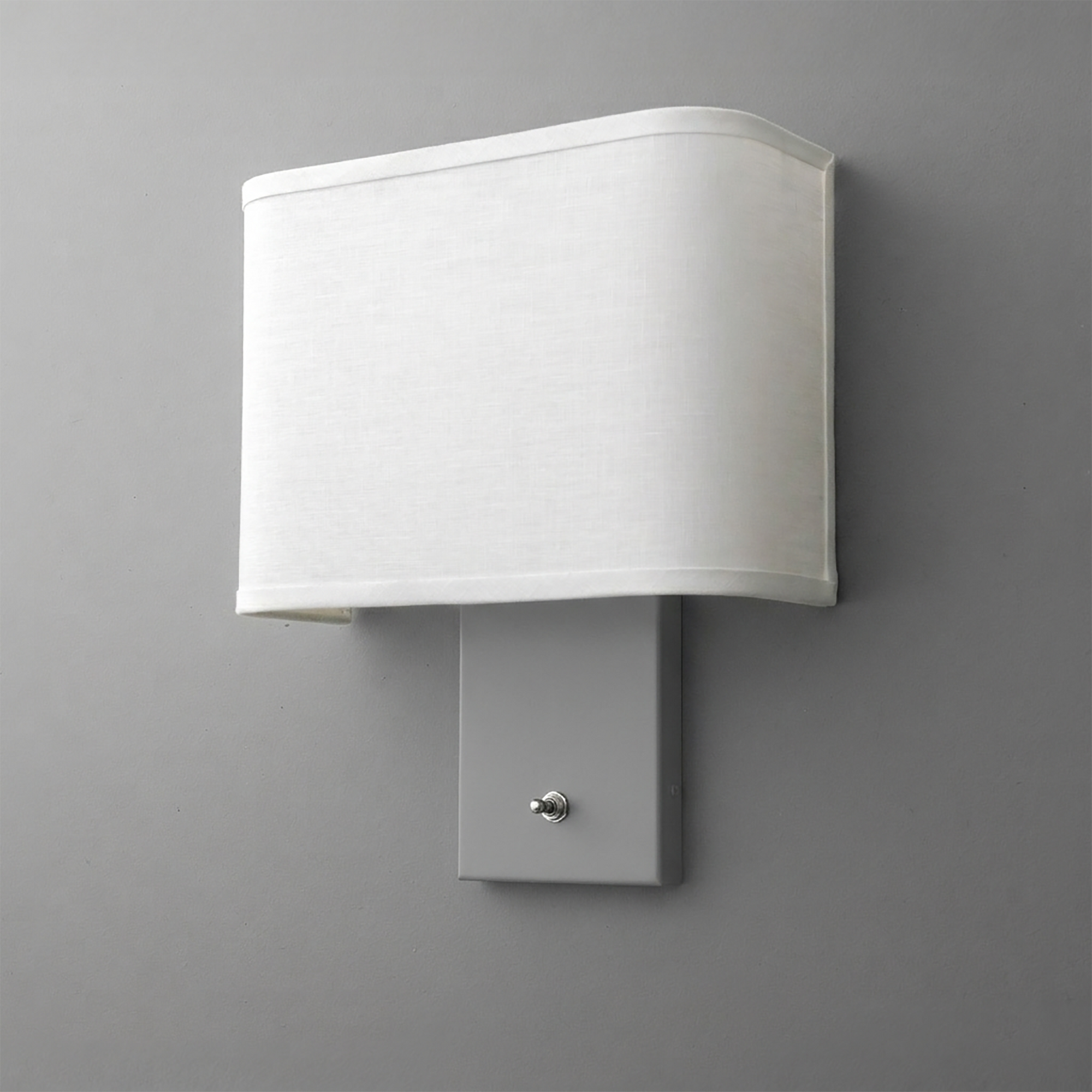 Wall-mounted sconce with rectangular white fabric shade and matte gray metal base with small on/off switch. - SCONCE MODEL NO. 7769