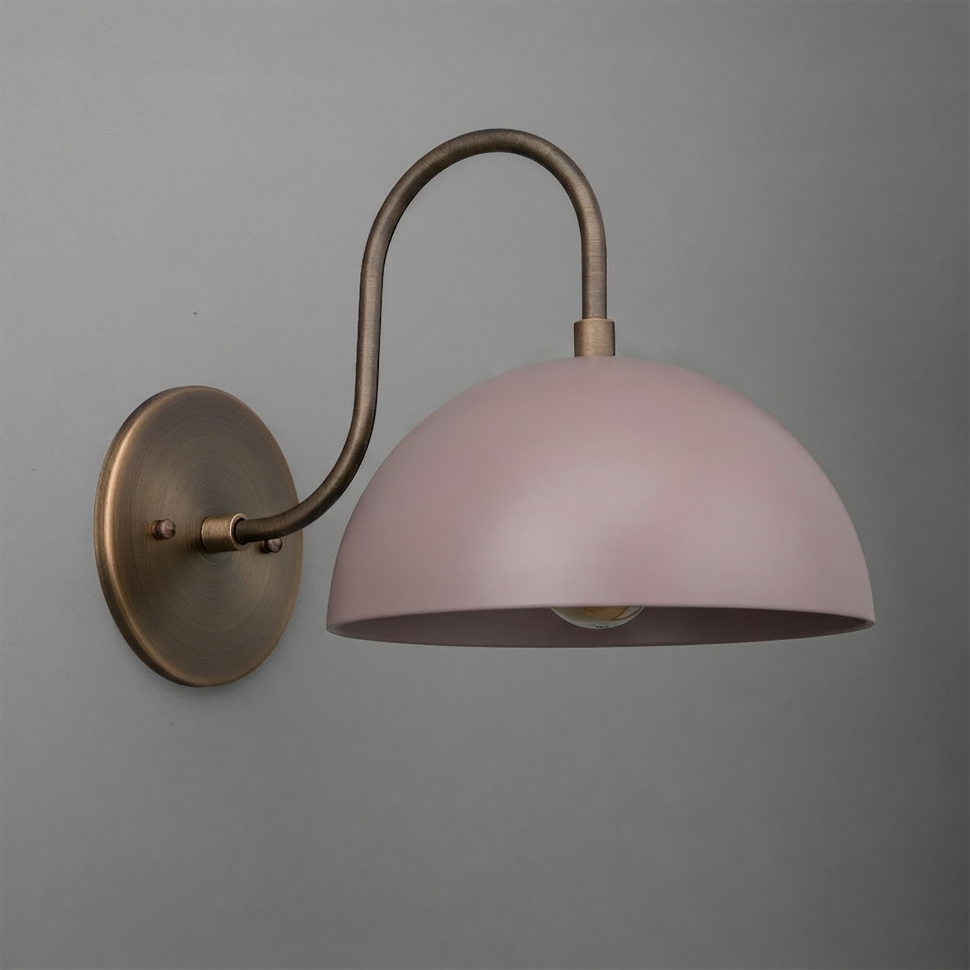 Wall sconce with dome-shaped pink metal shade and curved antique brass arm and round base. - SCONCE MODEL NO. 9092
