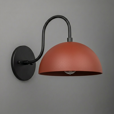 Black metal wall sconce with curved arm and matte terracotta dome shade covering one bulb. - SCONCE MODEL NO. 9092