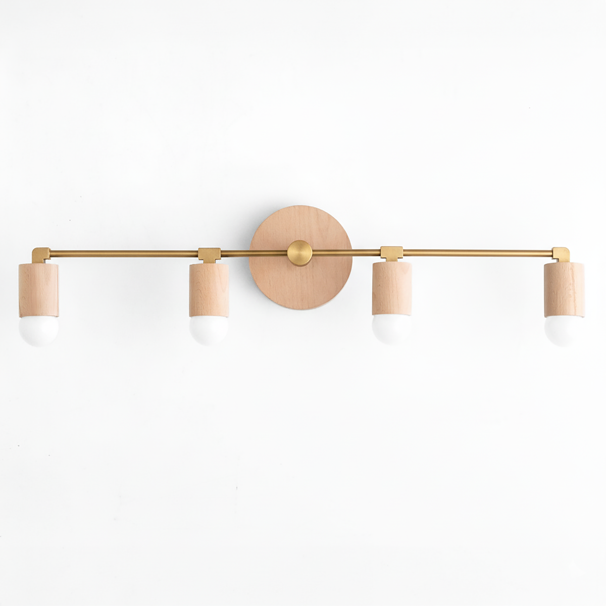 Four-bulb vanity light with raw brass finish and natural wood cylindrical sockets on wall mount. - VANITY LIGHT MODEL NO. 2017