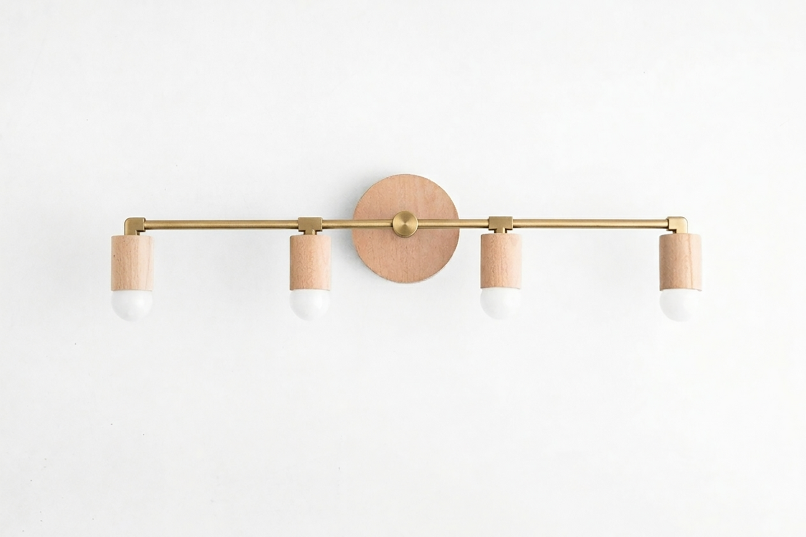 Four-bulb vanity light with natural wood base and brass-toned horizontal bar, white socket covers. - VANITY LIGHT MODEL NO. 2017