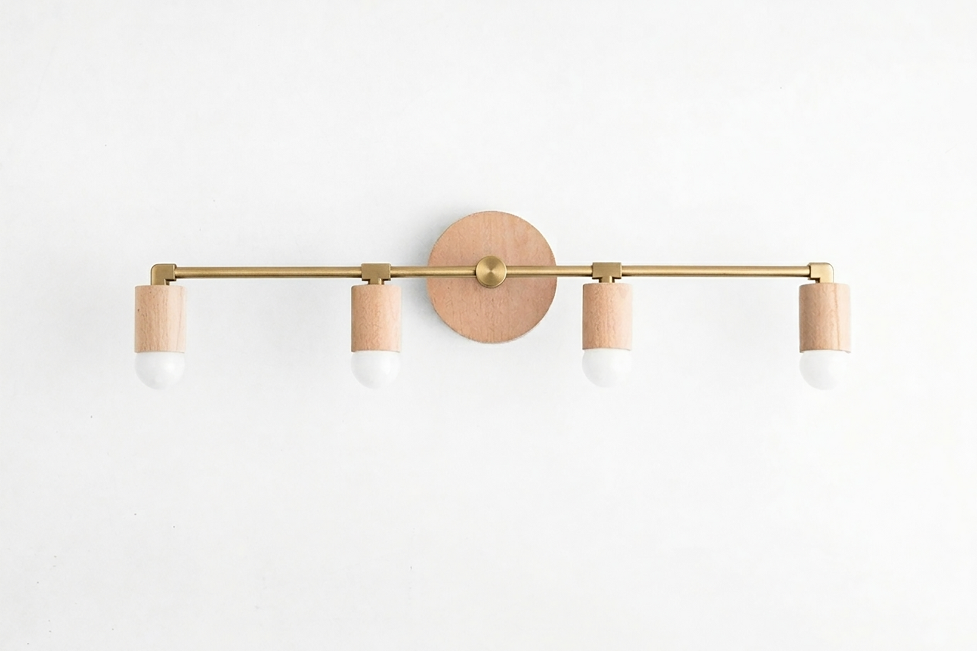 Four-bulb vanity light with natural wood base and brass-toned horizontal bar, white socket covers. - VANITY LIGHT MODEL NO. 2017