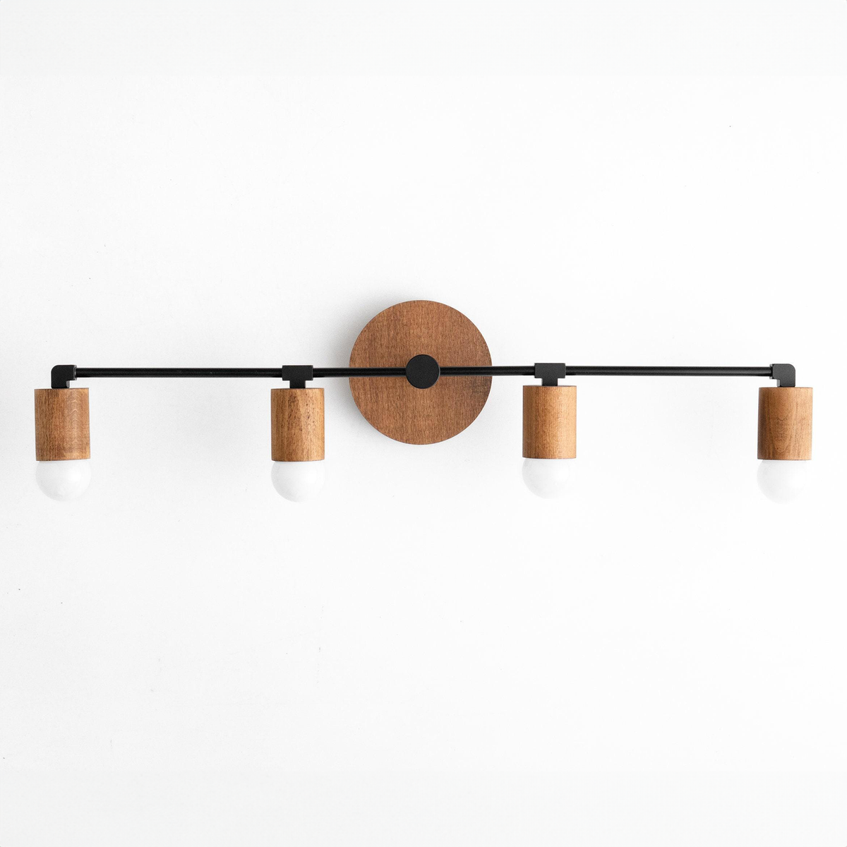 Four-bulb vanity light with natural wood and black metal accents on round wood backplate. - VANITY LIGHT MODEL NO. 2017