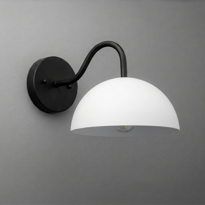 Wall-mounted sconce with matte black curved arm and round base, featuring a white dome-shaped glass shade. - SCONCE MODEL NO. 6678
