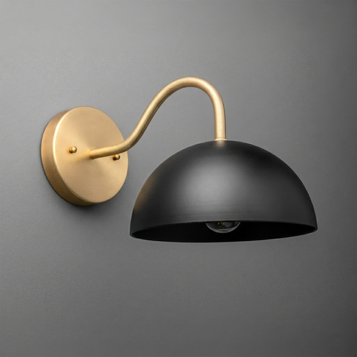 Matte black dome-shaped metal wall sconce with curved gold arm and round gold mounting plate. - SCONCE MODEL NO. 6678