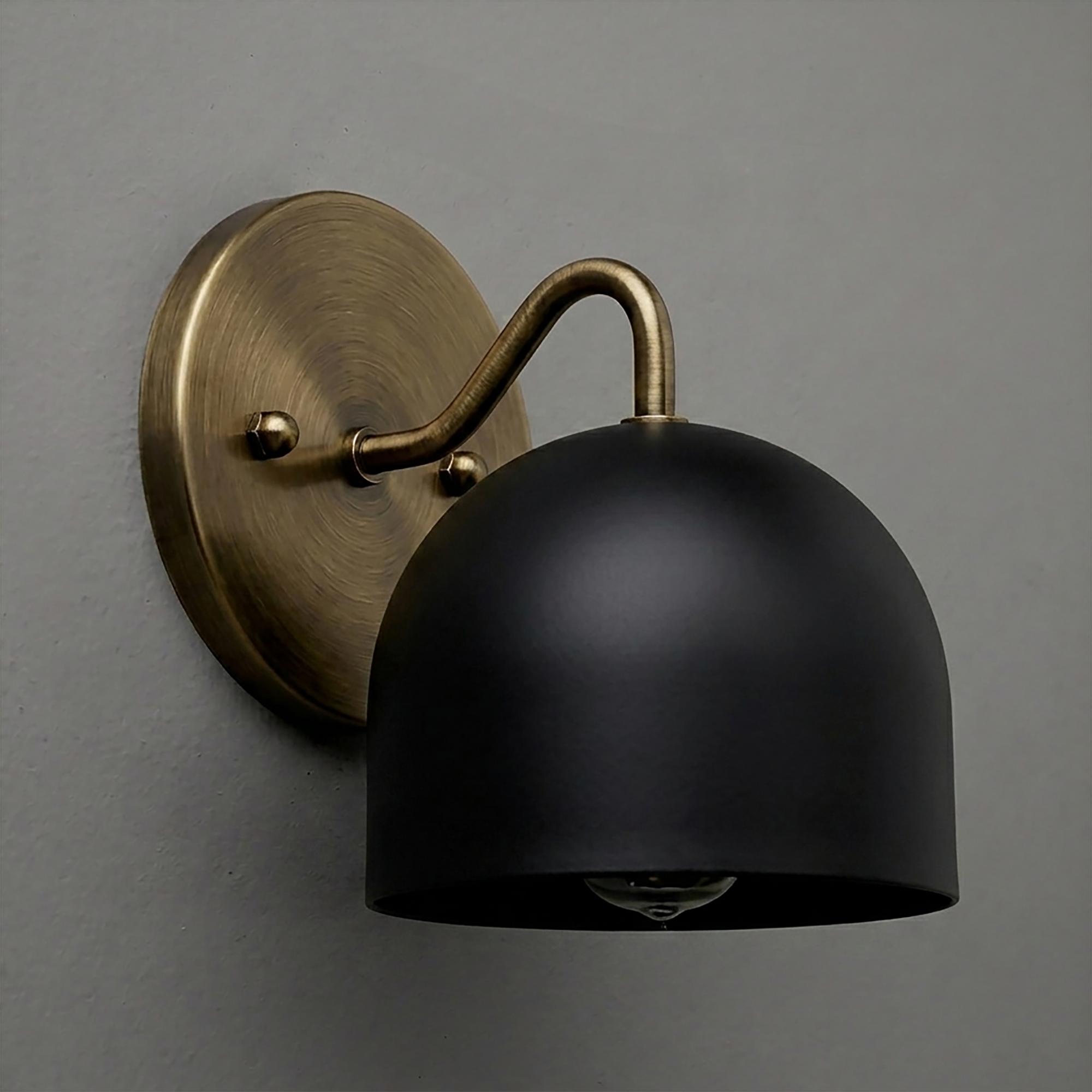 Black dome-shaped metal sconce with brushed brass arm and round wall mount. - SCONCE MODEL NO. 9436