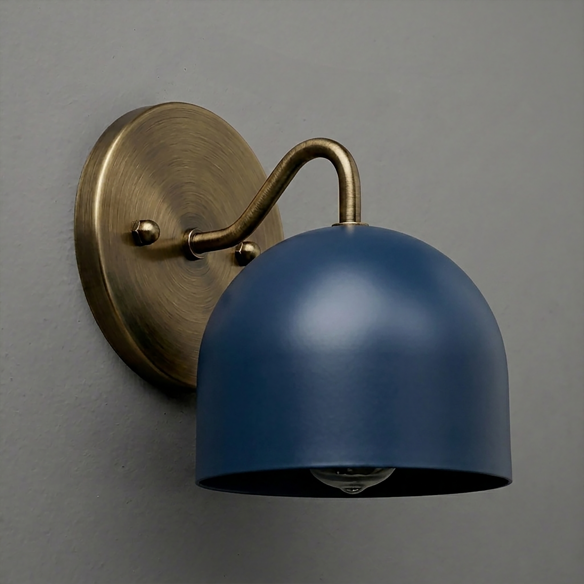 Wall sconce with a matte blue dome-shaped shade and antique brass curved arm on a round brass base. - SCONCE MODEL NO. 9436