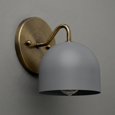 Wall sconce with matte gray bell-shaped metal shade and antique brass curved arm on an oval brass backplate. - SCONCE MODEL NO. 9436
