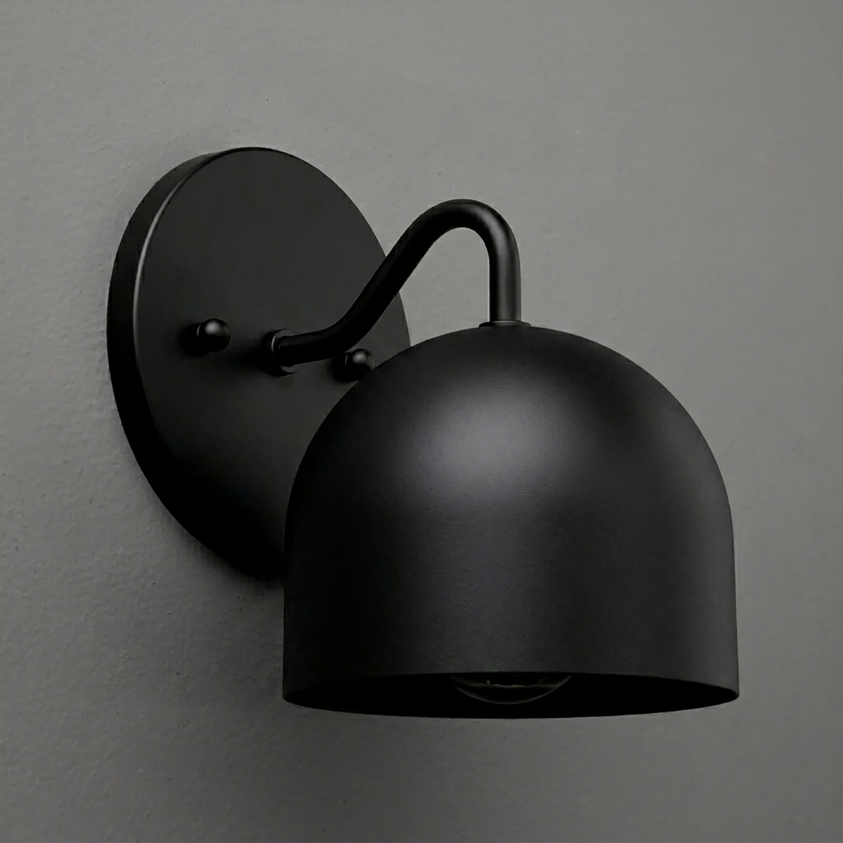 Matte black metal wall sconce with dome-shaped shade and curved arm mounting on round backplate. - SCONCE MODEL NO. 9436