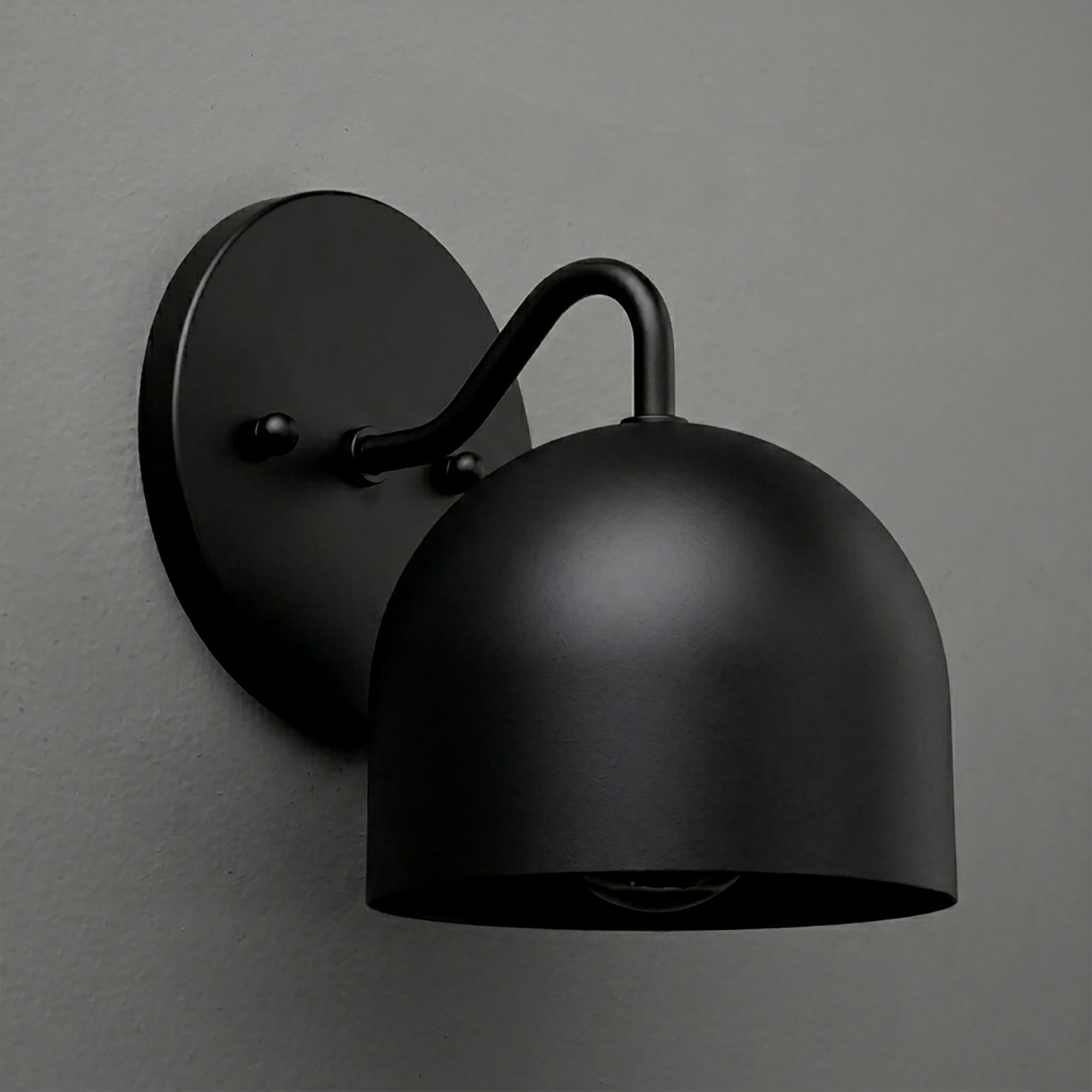 Matte black metal wall sconce with dome-shaped shade and curved arm mounting on round backplate. - SCONCE MODEL NO. 9436