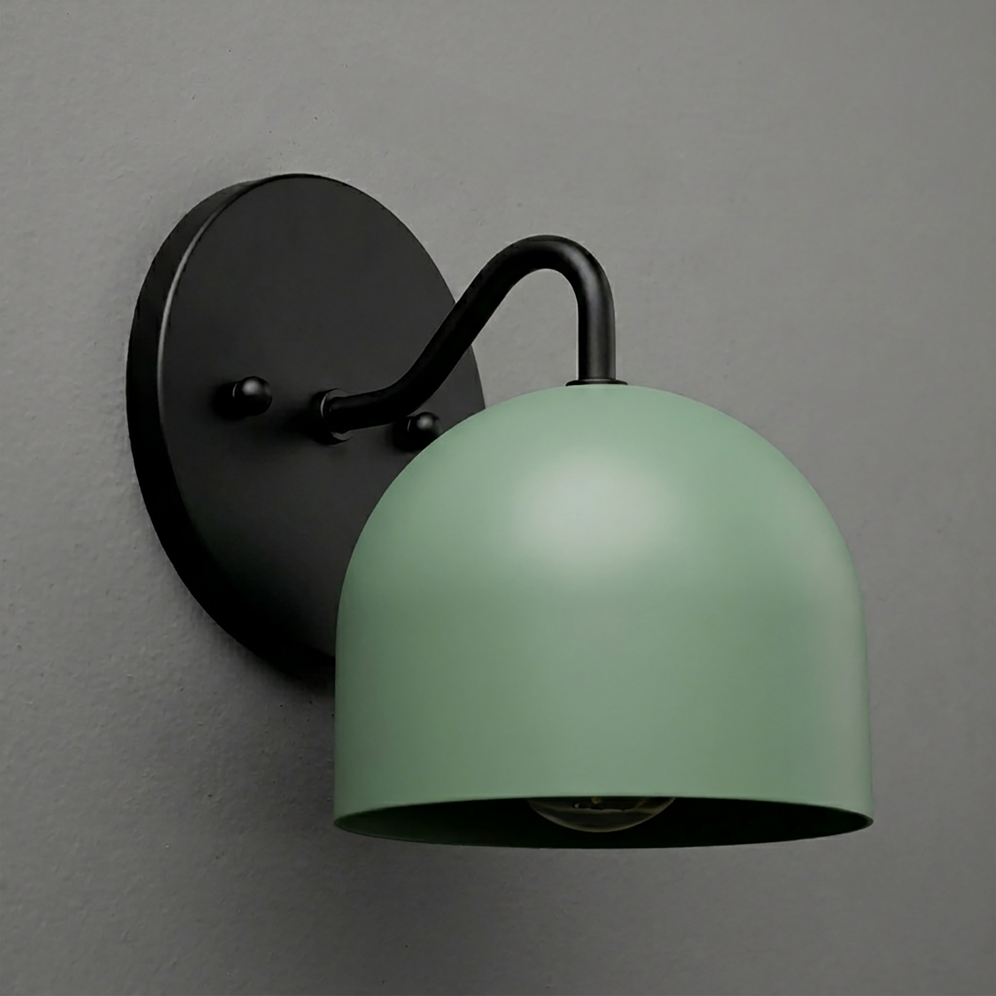 Matte black wall sconce with curved arm and muted green dome-shaped metal shade. - SCONCE MODEL NO. 9436