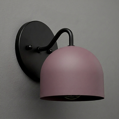 Black metal wall sconce with curved arm and matte pink dome-shaped shade, single bulb design. - SCONCE MODEL NO. 9436