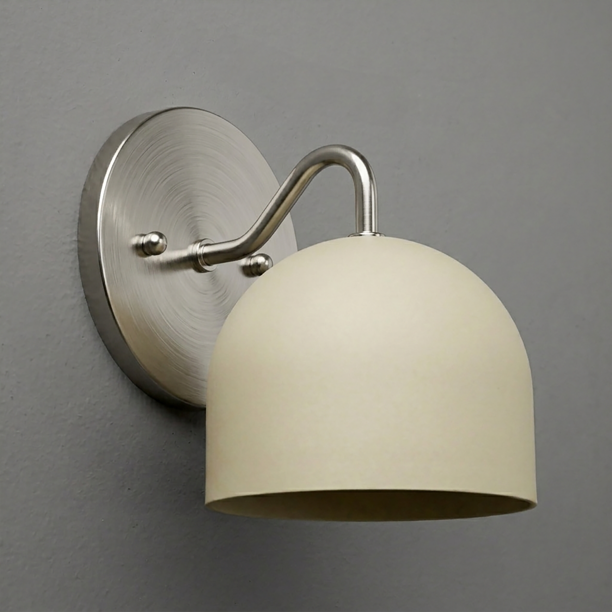 Brushed nickel wall sconce with curved arm and matte cream dome-shaped shade. - SCONCE MODEL NO. 9436