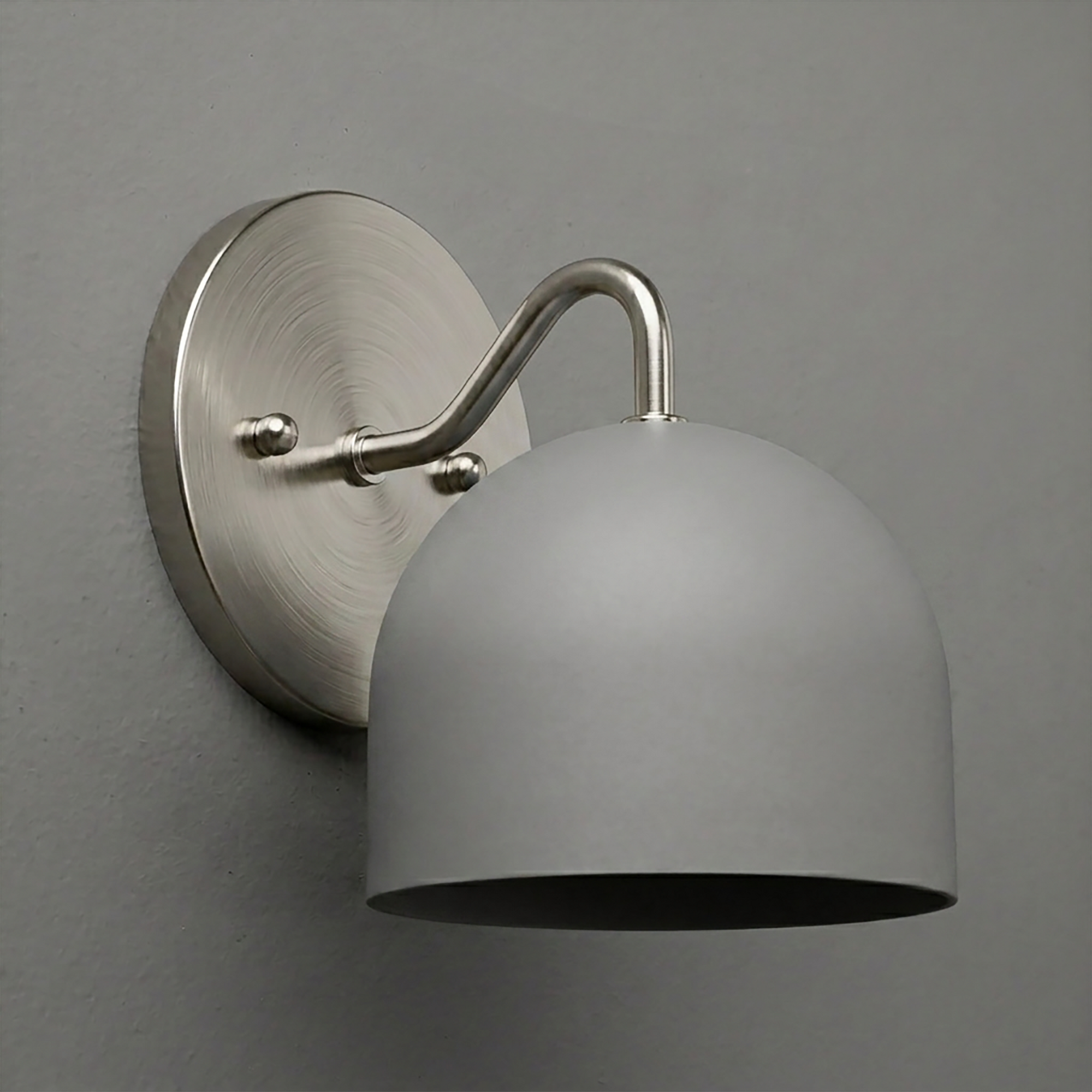 Matte silver metal wall sconce with rounded deep dome shade and curved arm mounting on circular base. - SCONCE MODEL NO. 9436