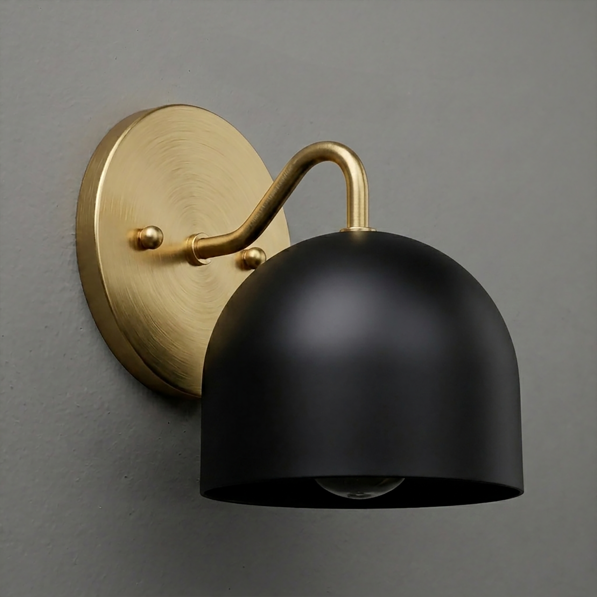 Matte black dome-shaped metal sconce with brass arm and round brass wall plate. - SCONCE MODEL NO. 9436
