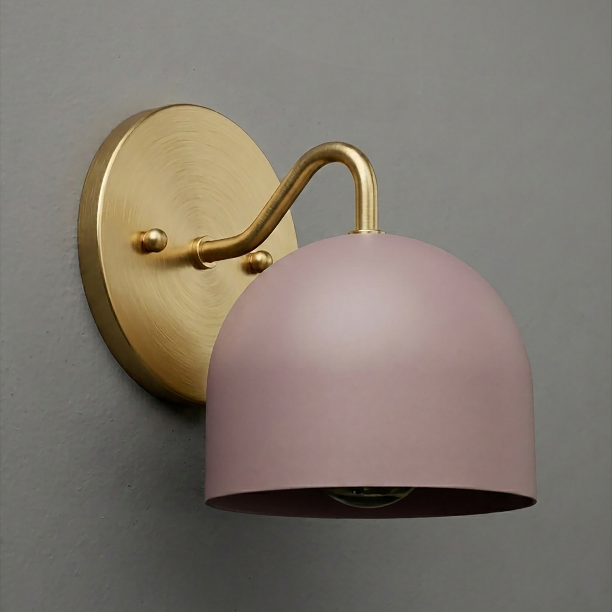 Brushed brass wall sconce with a curved arm and matte pink dome-shaped metal shade. - SCONCE MODEL NO. 9436