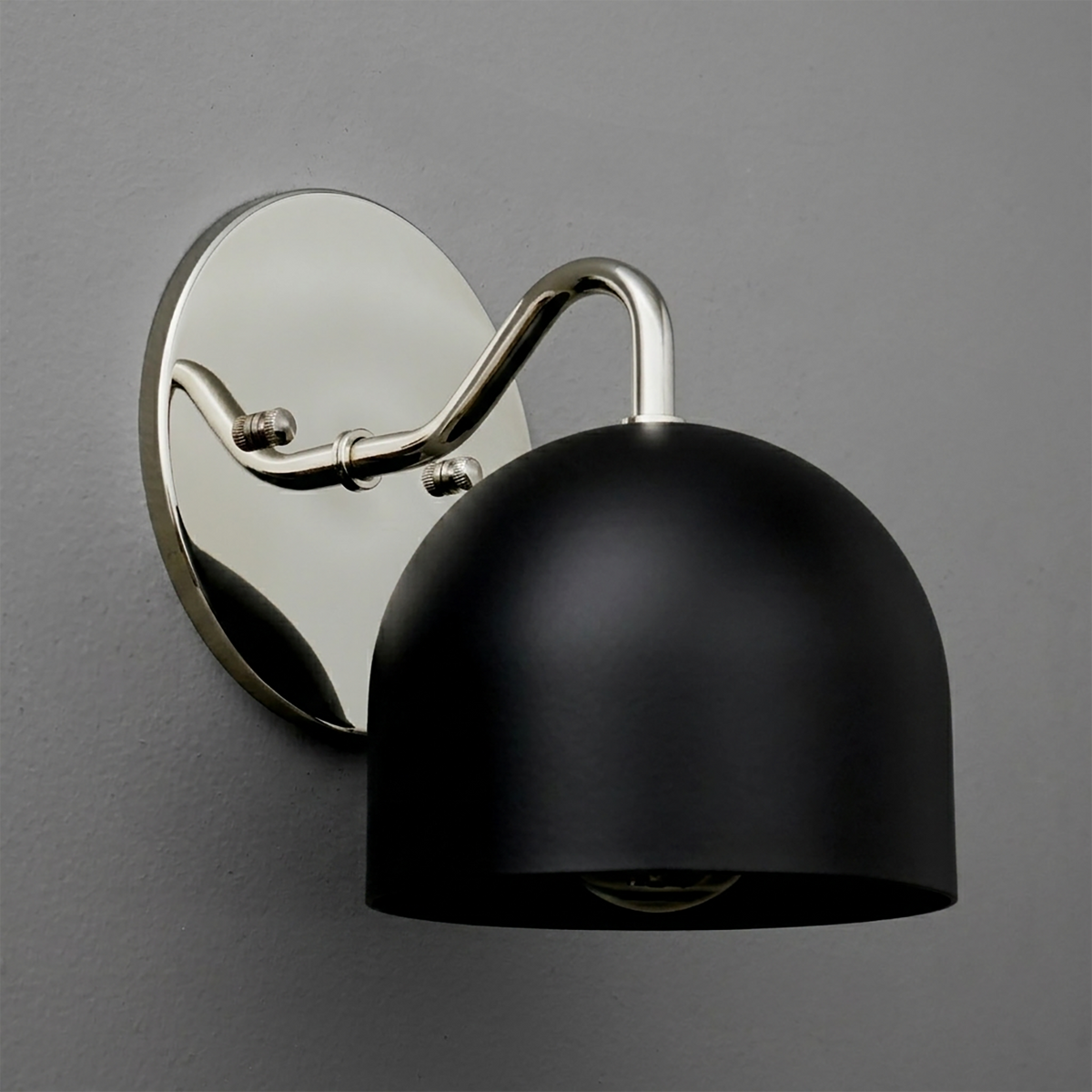 Black matte dome-shaped metal sconce with polished silver curved arm and oval backplate. - SCONCE MODEL NO. 9436