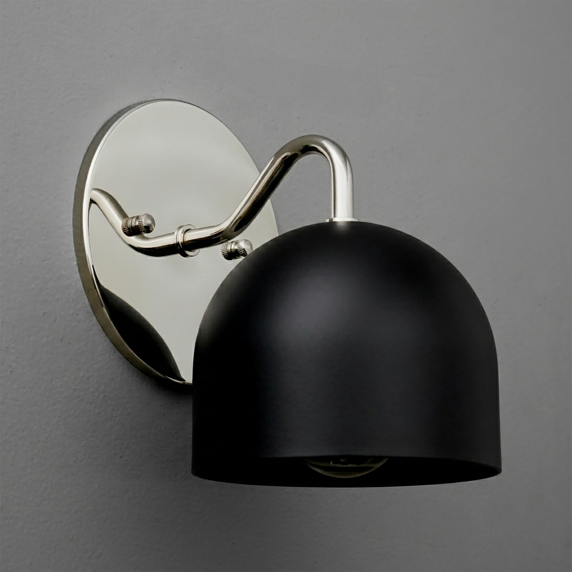 Black matte dome-shaped metal sconce with polished silver curved arm and oval backplate. - SCONCE MODEL NO. 9436