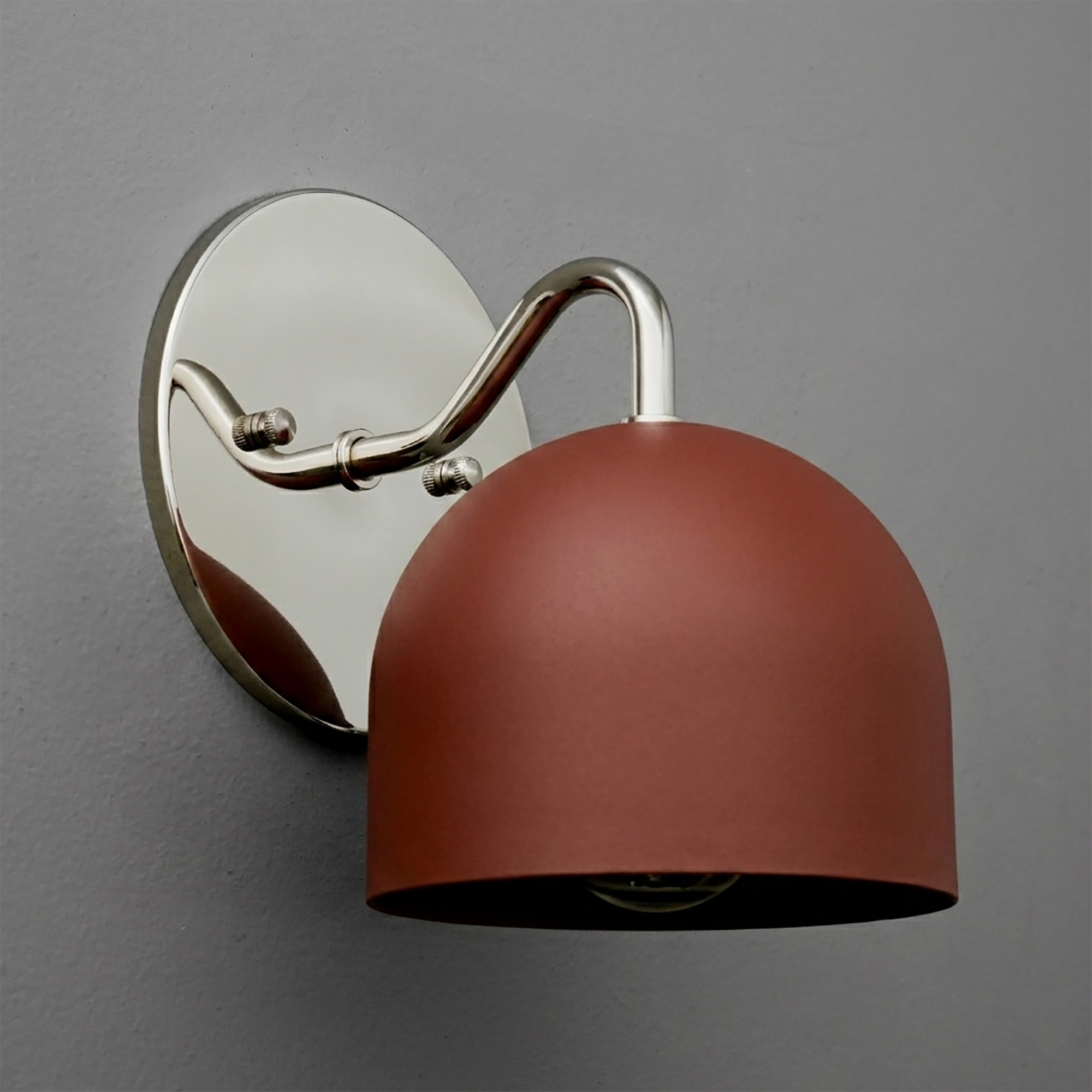 Wall sconce with matte rust-red dome shade and polished chrome curved arm on oval chrome backplate. - SCONCE MODEL NO. 9436