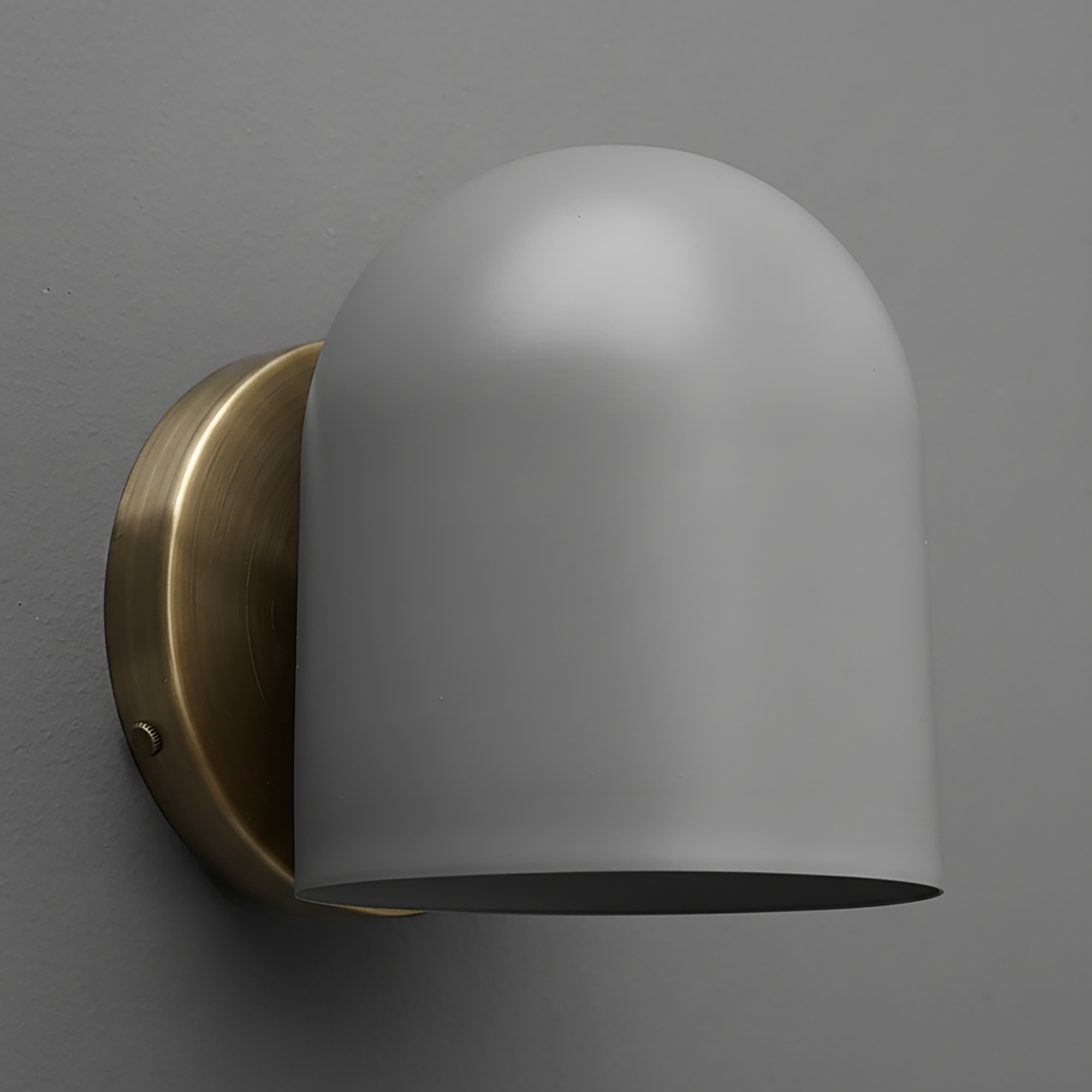 Matte white dome-shaped metal sconce with brushed brass wall mount on gray background. - SCONCE MODEL NO. 2424