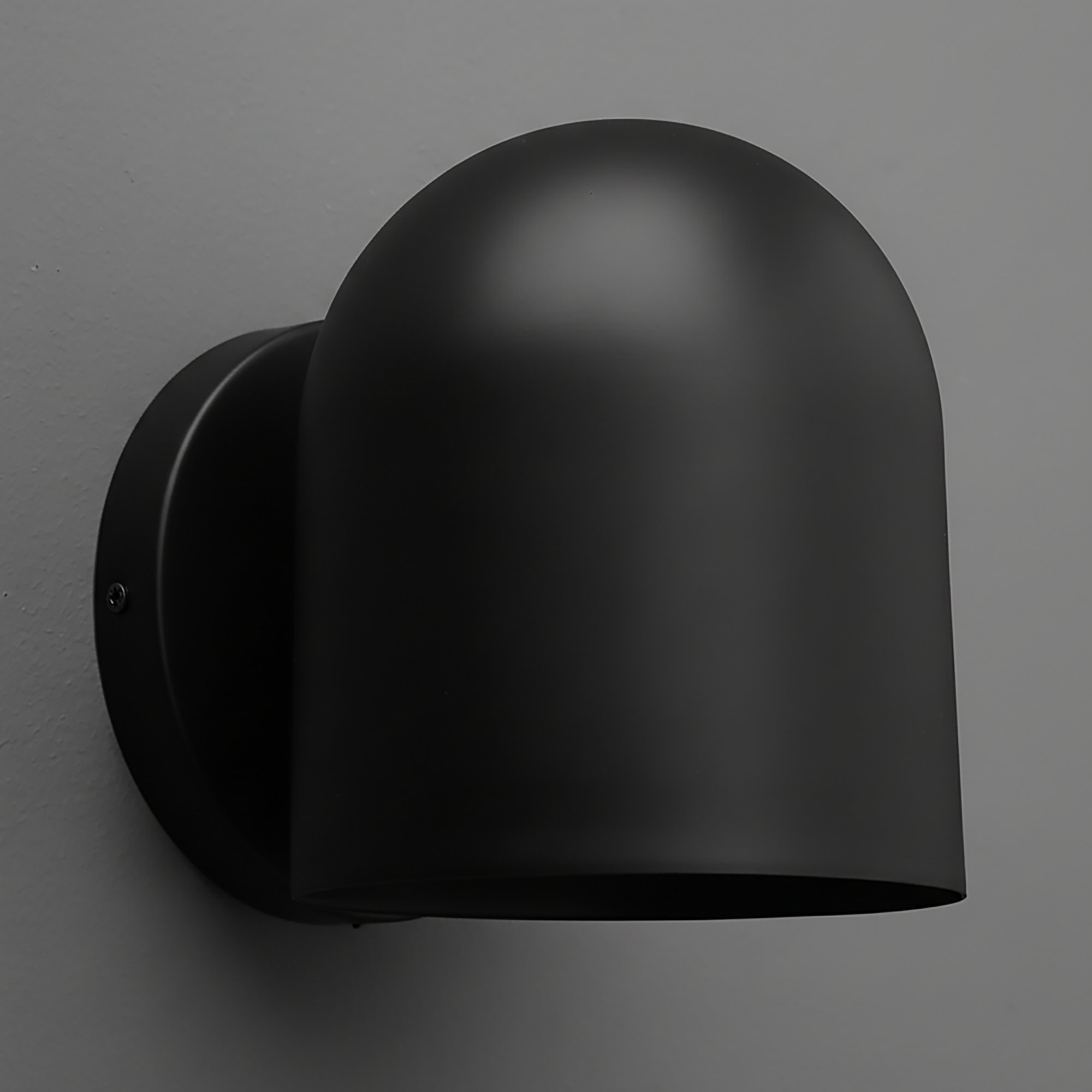 Matte black metal wall sconce with rounded dome-shaped shade and circular mounting plate. - SCONCE MODEL NO. 2424