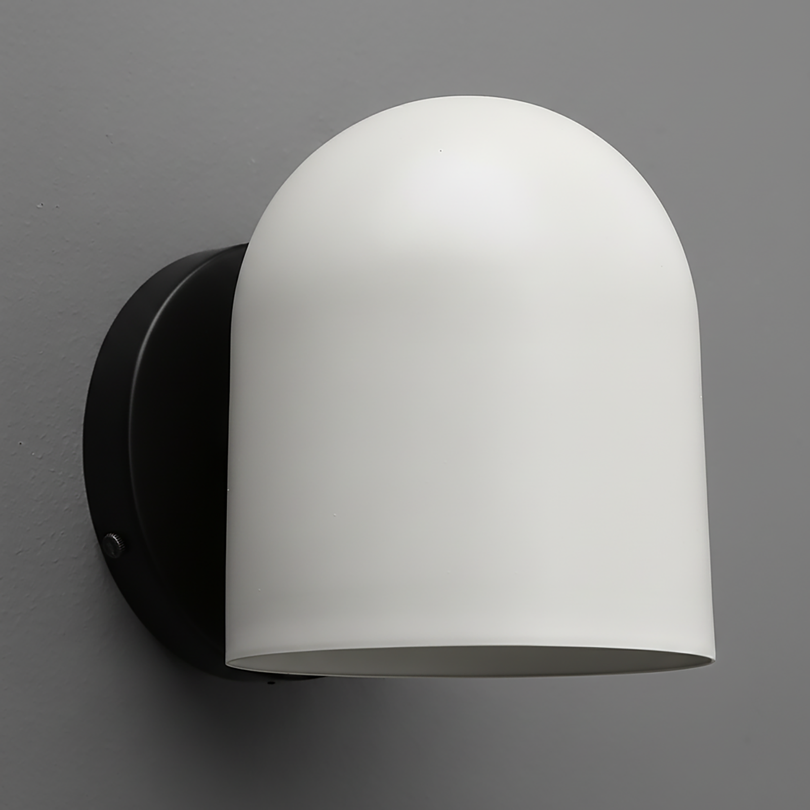 Matte white dome-shaped wall sconce with smooth surface and black round mounting plate. - SCONCE MODEL NO. 2424