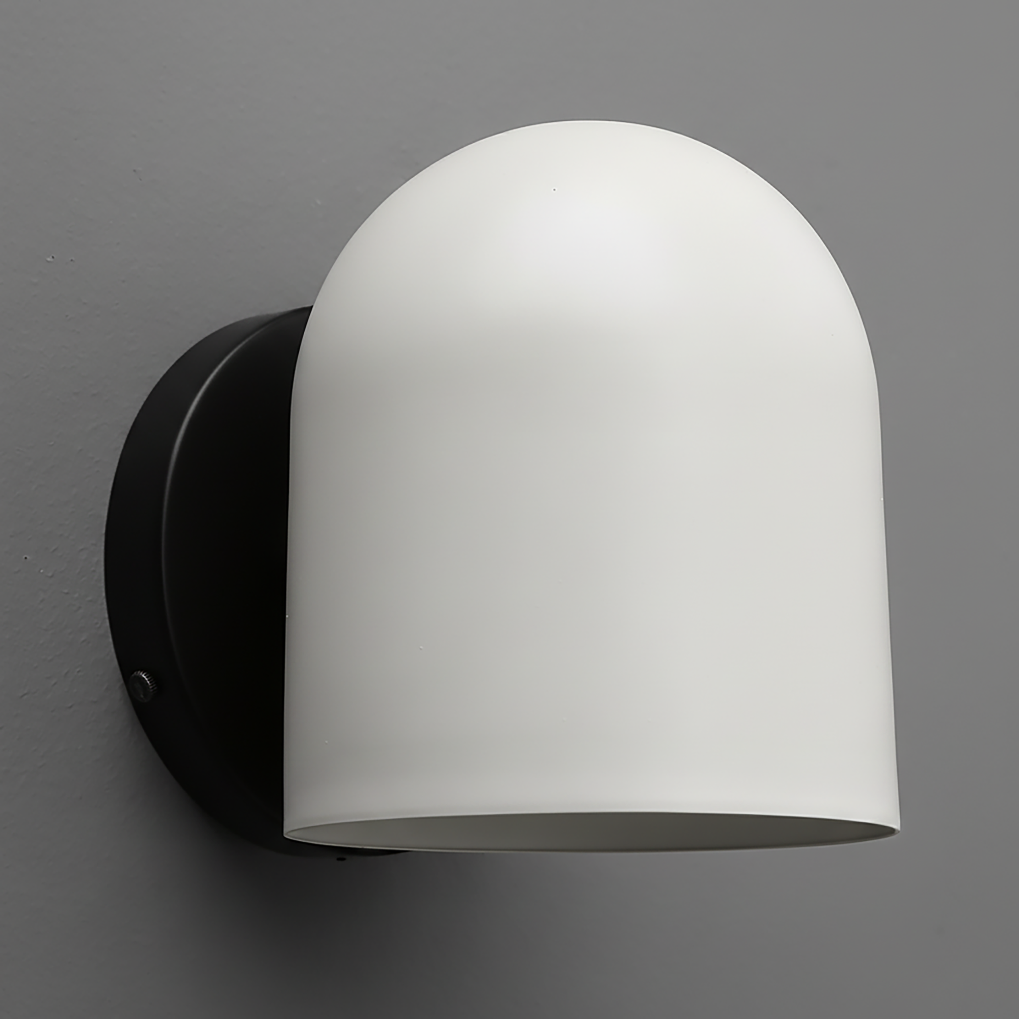 Matte white dome-shaped wall sconce with smooth surface and black round mounting plate. - SCONCE MODEL NO. 2424
