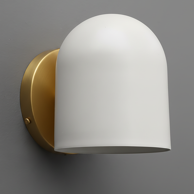 Wall-mounted sconce with matte white dome shade and antique brass base against gray wall. - SCONCE MODEL NO. 2424
