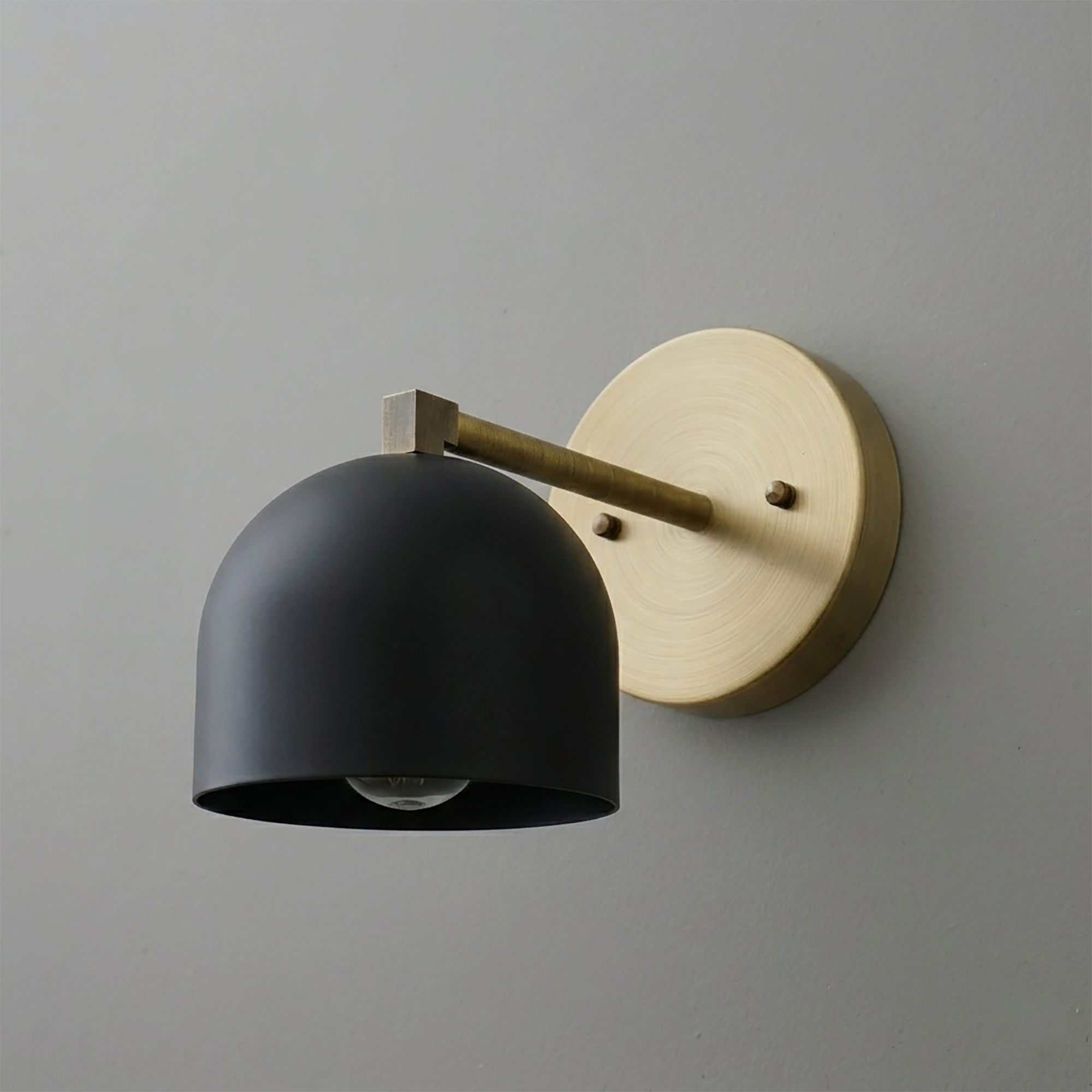 Matte black dome-shaped metal shade sconce with brass arm and round brass wall mount. - SCONCE MODEL NO. 3622