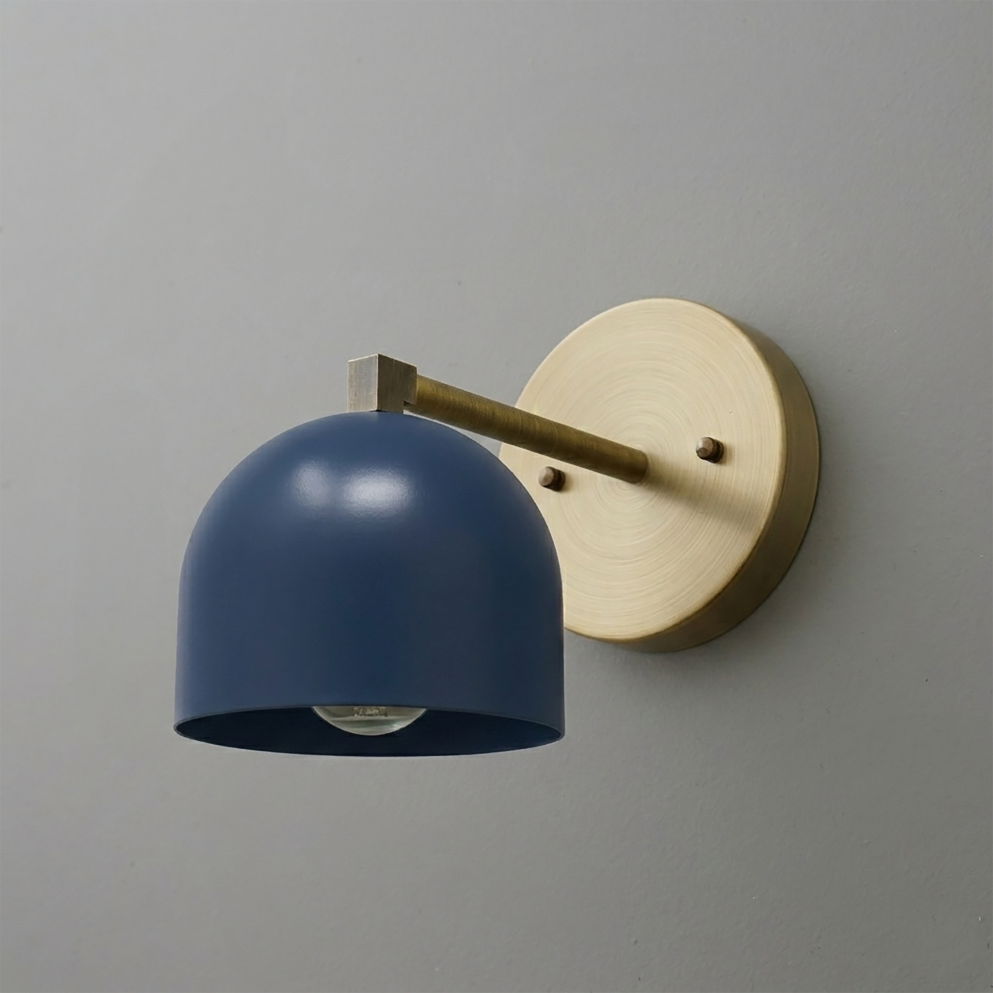Matte navy blue dome-shaped metal shade wall sconce with brushed brass arm and round backplate. - SCONCE MODEL NO. 3622