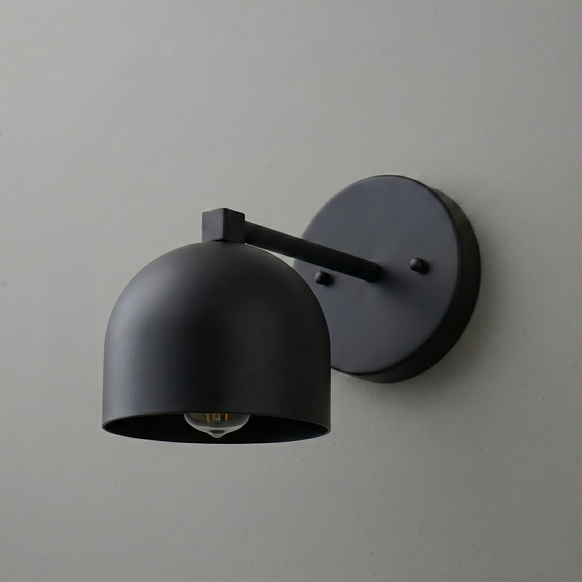 Matte black metal wall sconce with dome-shaped shade and exposed bulb, modern minimalist design. - SCONCE MODEL NO. 3622