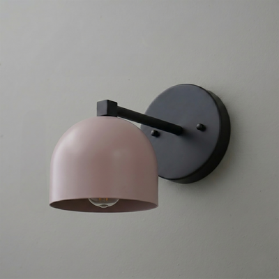 Matte black wall-mounted sconce with a deep, rounded pale pink metal shade and exposed bulb. - SCONCE MODEL NO. 3622