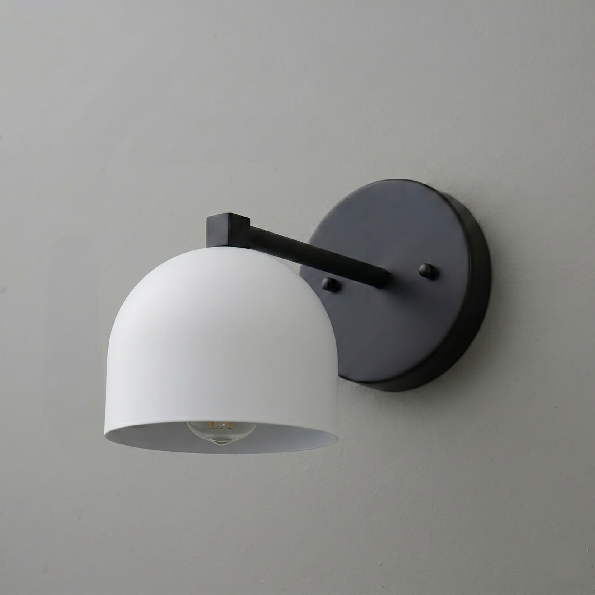 Matte black metal wall sconce with a deep white dome-shaped shade and exposed bulb design. - SCONCE MODEL NO. 3622