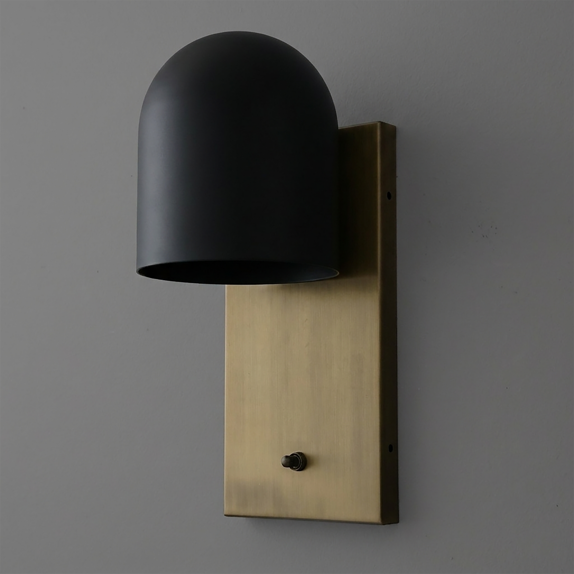 Wall sconce with matte black dome shade and rectangular brushed brass backplate, single bulb fixture. - SCONCE MODEL NO. 6029