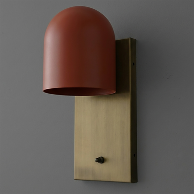 Wall sconce with a matte terracotta dome shade mounted on an aged brass rectangular backplate with a small black switch. - SCONCE MODEL NO. 6029