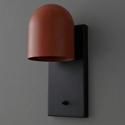 Wall sconce with matte black rectangular base and curved matte terracotta shade covering one bulb. - SCONCE MODEL NO. 6029