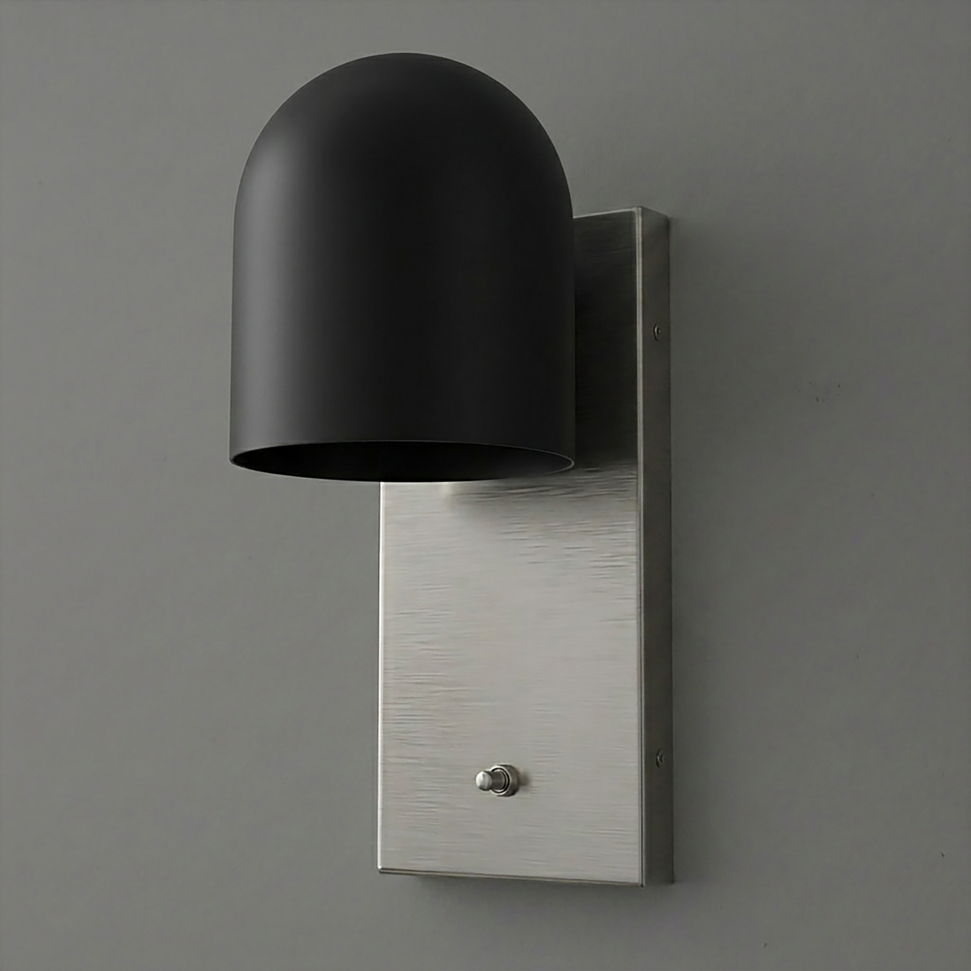 Matte black dome-shaped metal shade sconce on a brushed silver rectangular backplate with a small toggle switch. - SCONCE MODEL NO. 6029