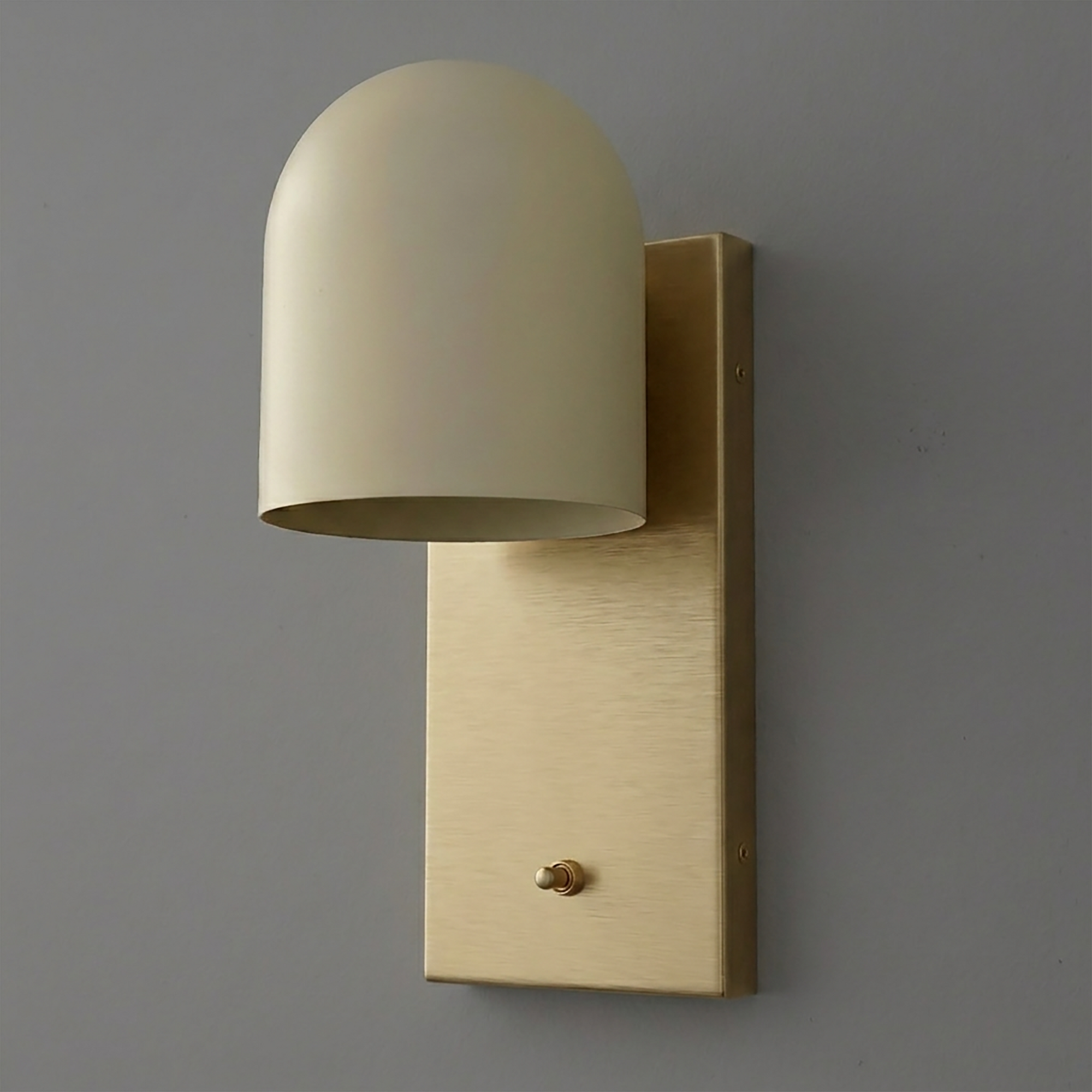 Matte gold metal wall sconce with a cylindrical dome shade and rectangular backplate with toggle switch. - SCONCE MODEL NO. 6029
