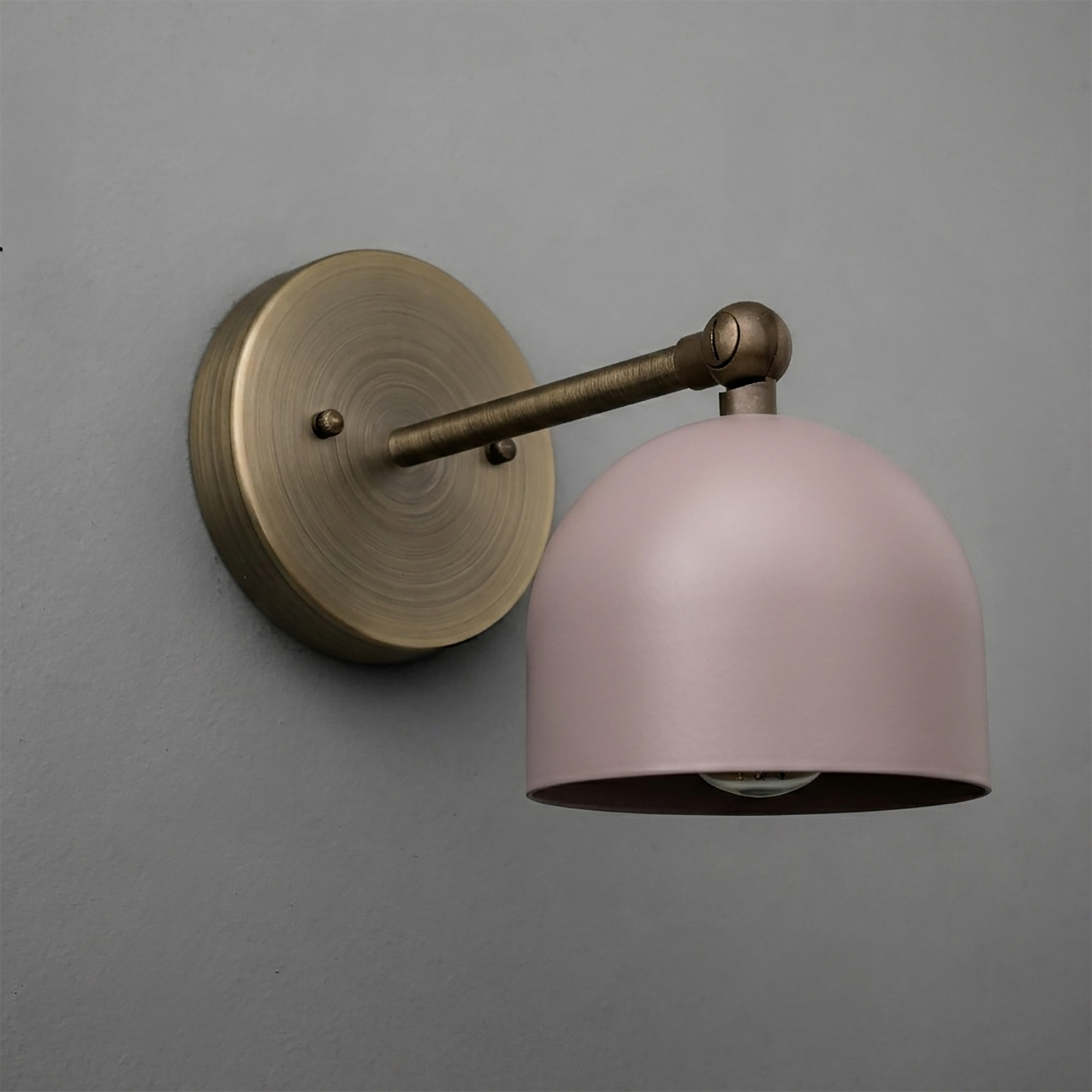 Wall-mounted sconce with antique brass finish arm and pink dome-shaped metal shade. - SCONCE MODEL NO. 5103