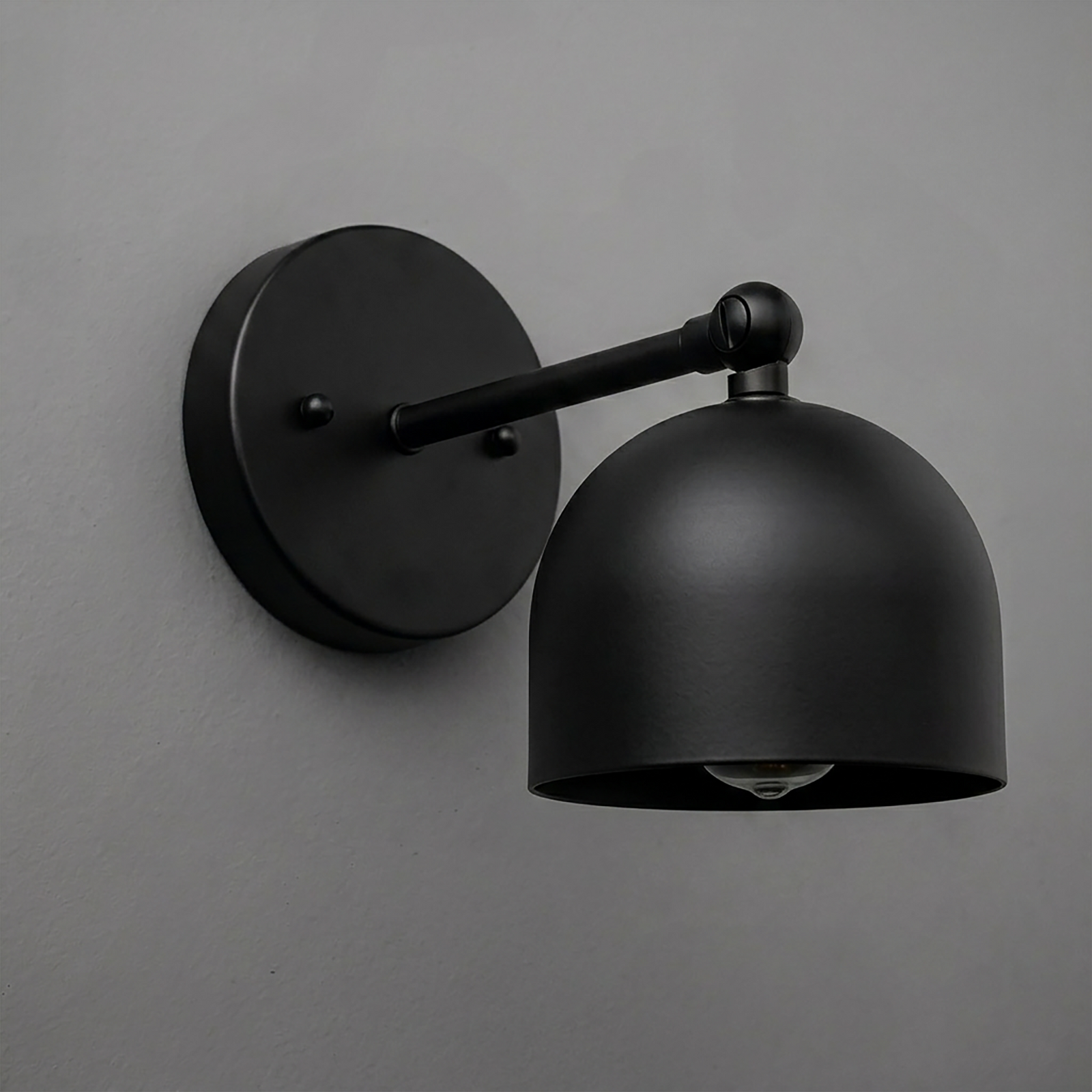 Matte black metal wall sconce with round backplate and dome-shaped shade, single bulb design. - SCONCE MODEL NO. 5103