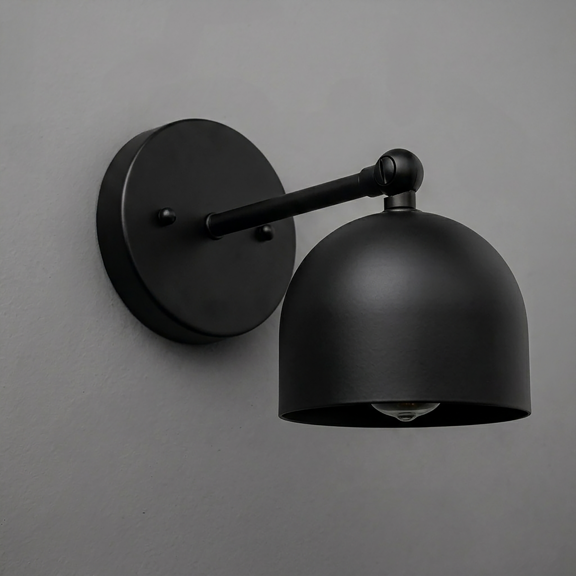 Matte black metal wall sconce with round backplate and dome-shaped shade, single bulb design. - SCONCE MODEL NO. 5103