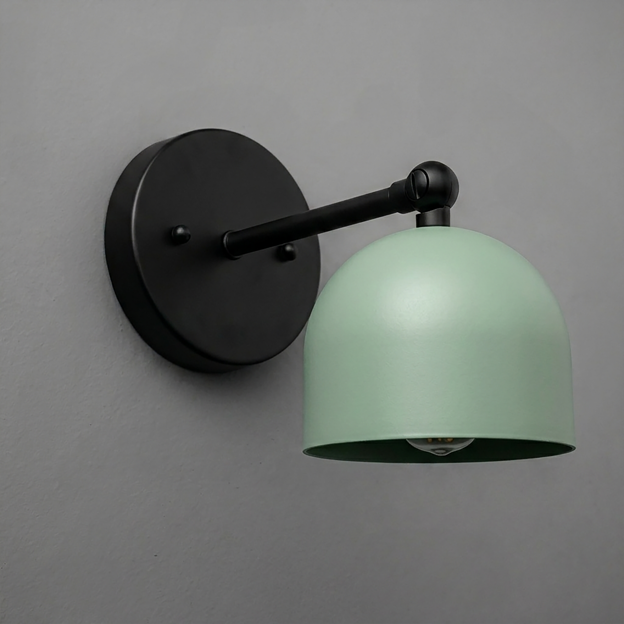 Matte black wall-mounted sconce with a curved arm and a smooth, light green dome-shaped metal shade. - SCONCE MODEL NO. 5103