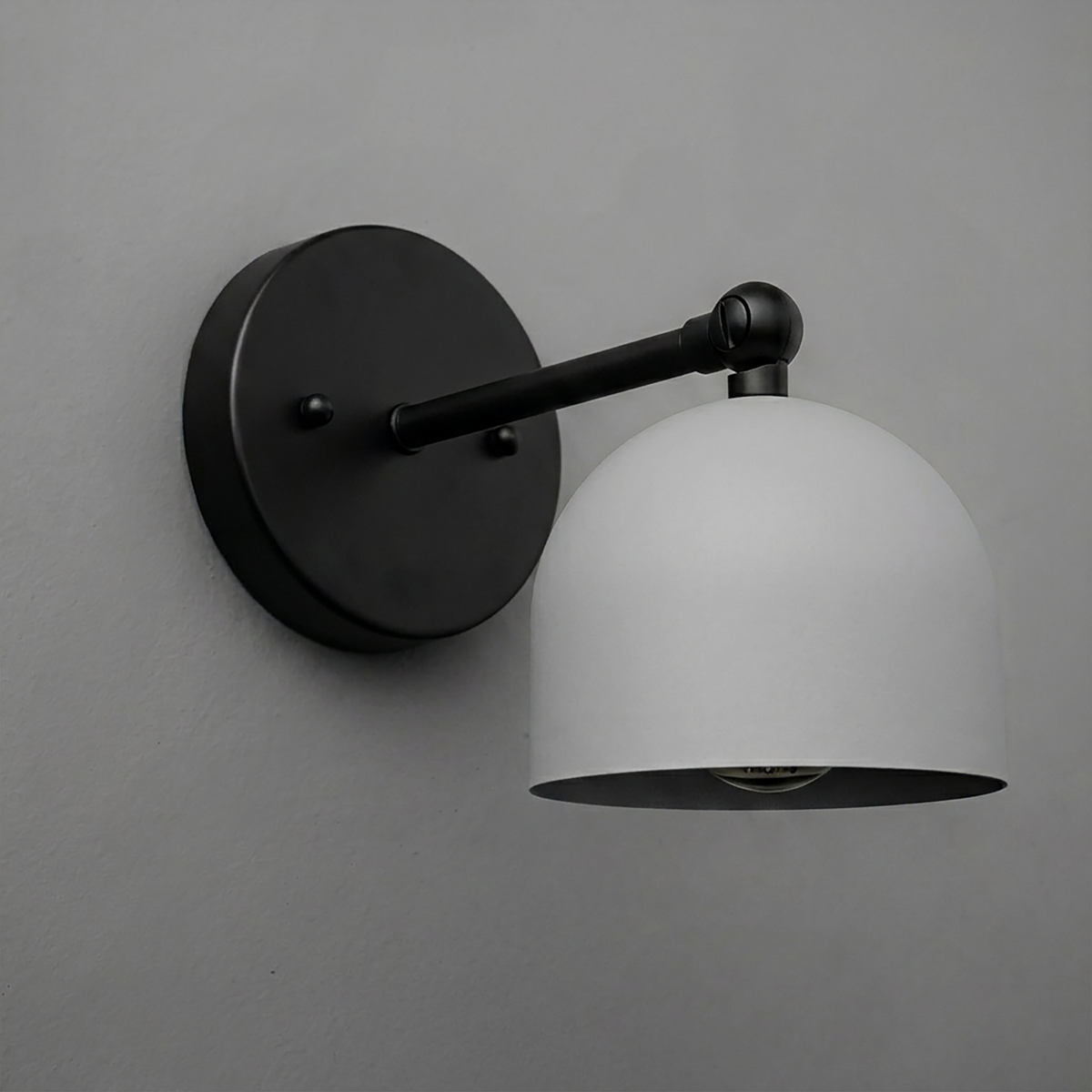 Matte black metal wall sconce with a smooth dome-shaped white shade and single bulb design. - SCONCE MODEL NO. 5103