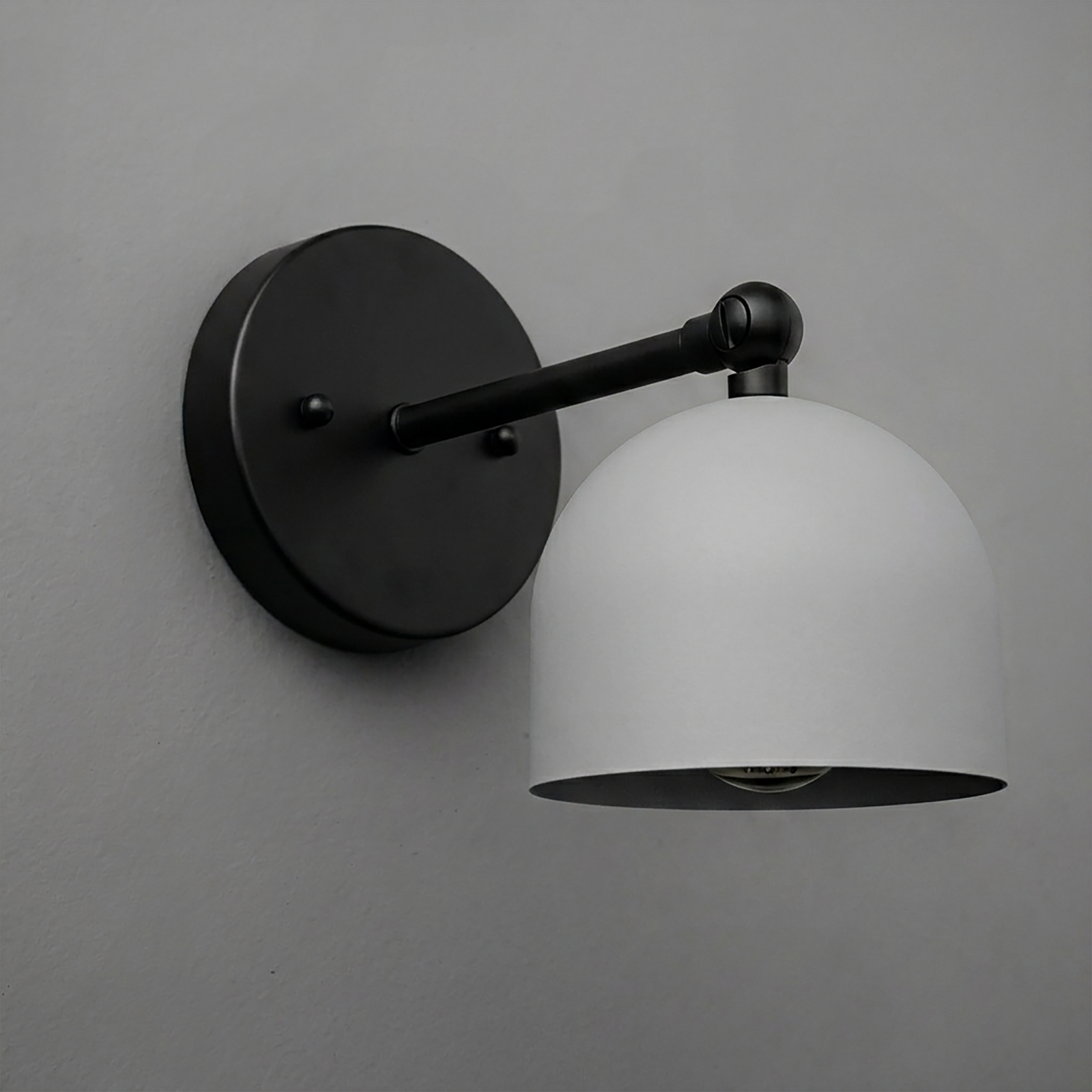 Matte black metal wall sconce with a smooth dome-shaped white shade and single bulb design. - SCONCE MODEL NO. 5103