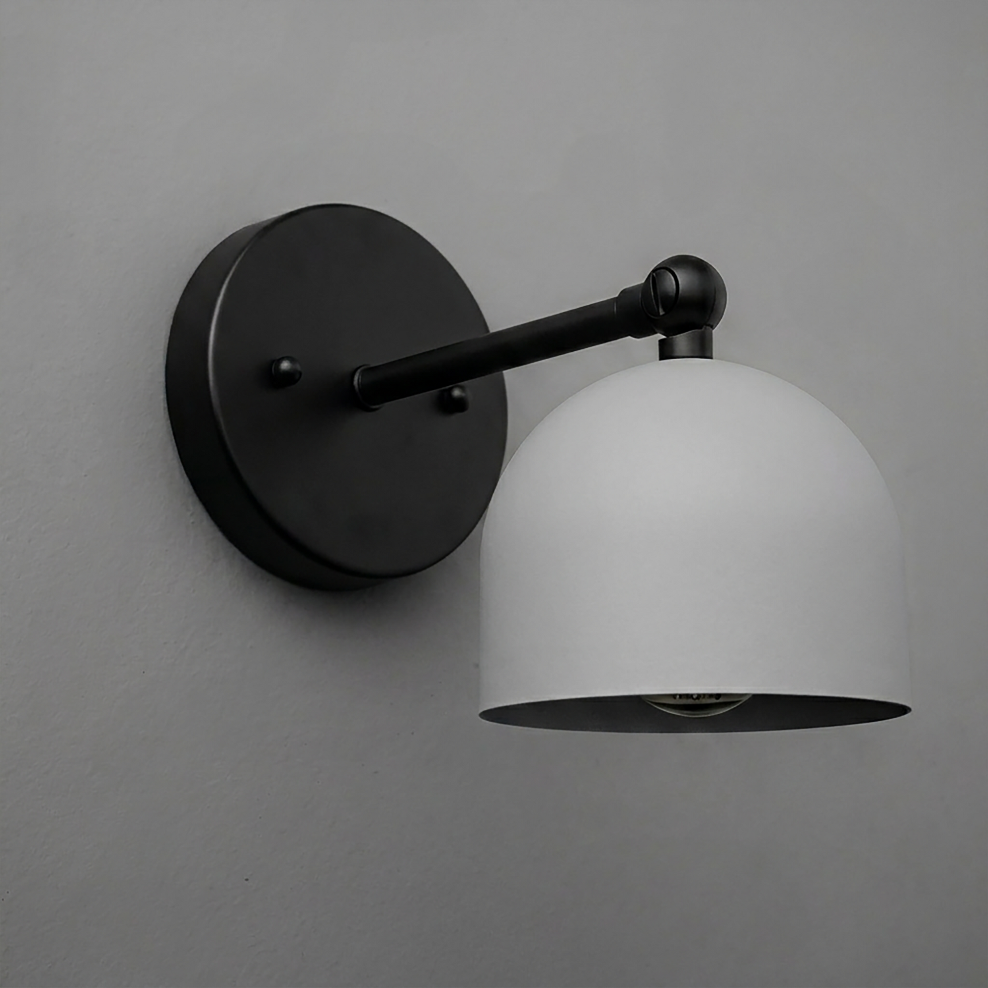 Matte black metal wall sconce with a smooth dome-shaped white shade and single bulb design. - SCONCE MODEL NO. 5103
