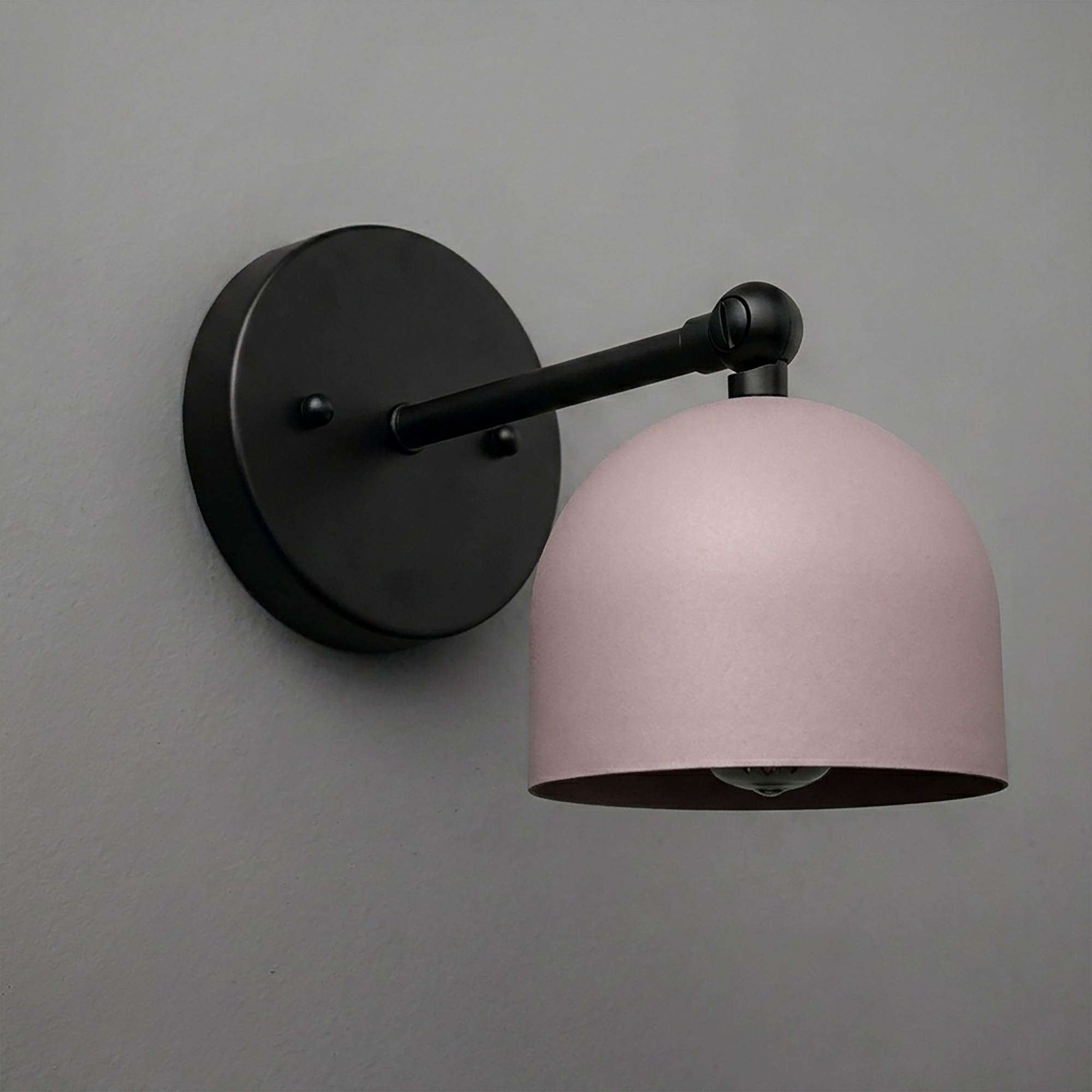 Matte black wall-mounted sconce with curved arm and matte pink dome-shaped shade. - SCONCE MODEL NO. 5103