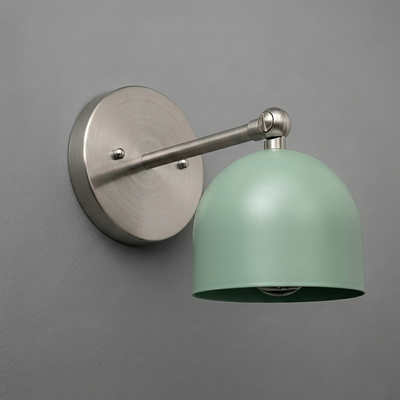 Matte silver metal wall sconce with round base and adjustable arm, featuring a smooth pastel green dome-shaped shade. - SCONCE MODEL NO. 5103