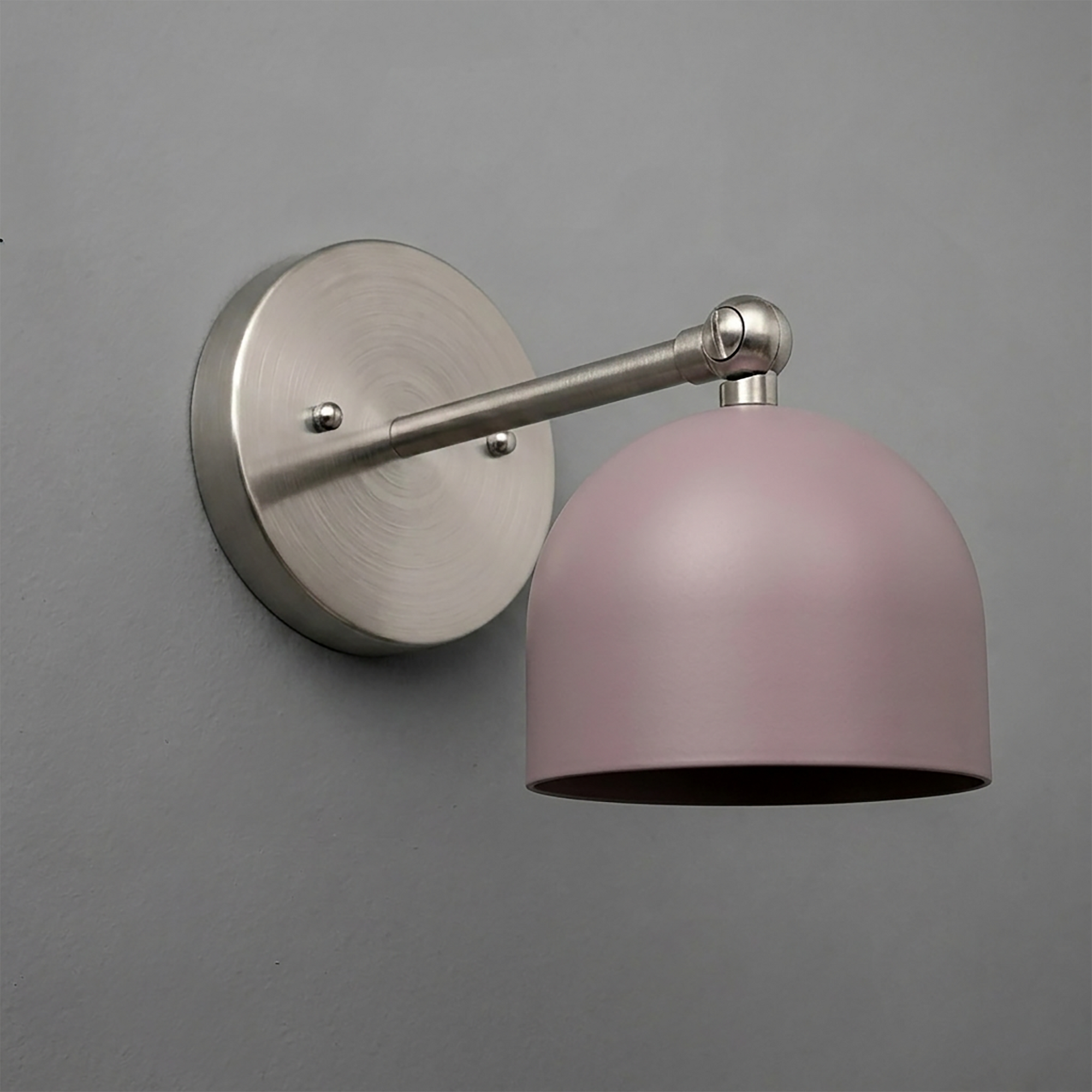 Wall-mounted sconce with brushed nickel arm and round base, featuring a matte pink dome-shaped shade. - SCONCE MODEL NO. 5103